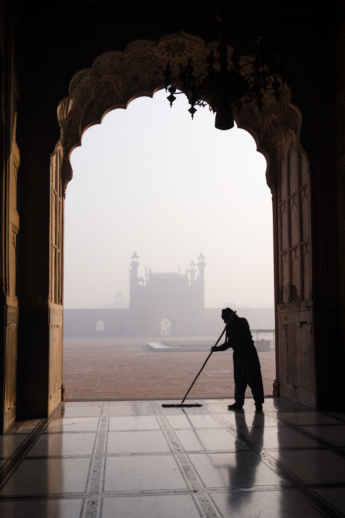  A man cleaning the floors before worshippers arrive 