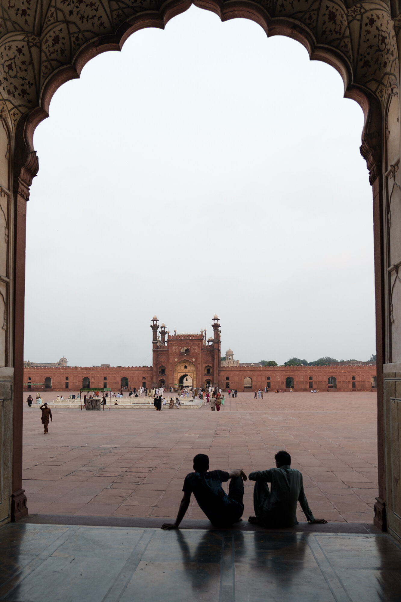  Two men gaze out at the courtyard 