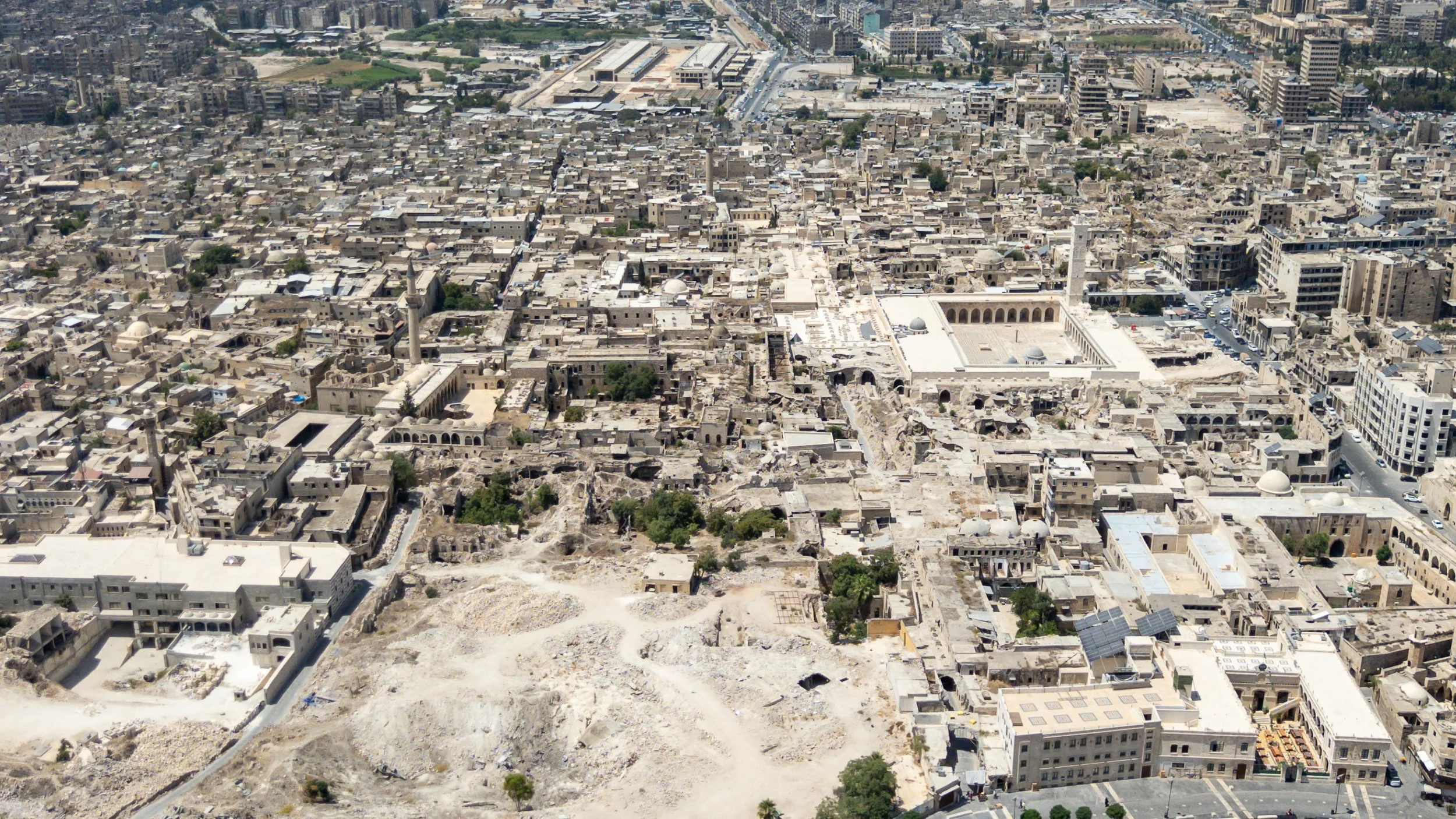  An aerial view of the souk area. Destruction resulting from the civil war can be seen in the foreground and in the centre of the image. Sections of the souk restored by the Aga Khan Trust for Culture can be seen to the left of the mosque. 