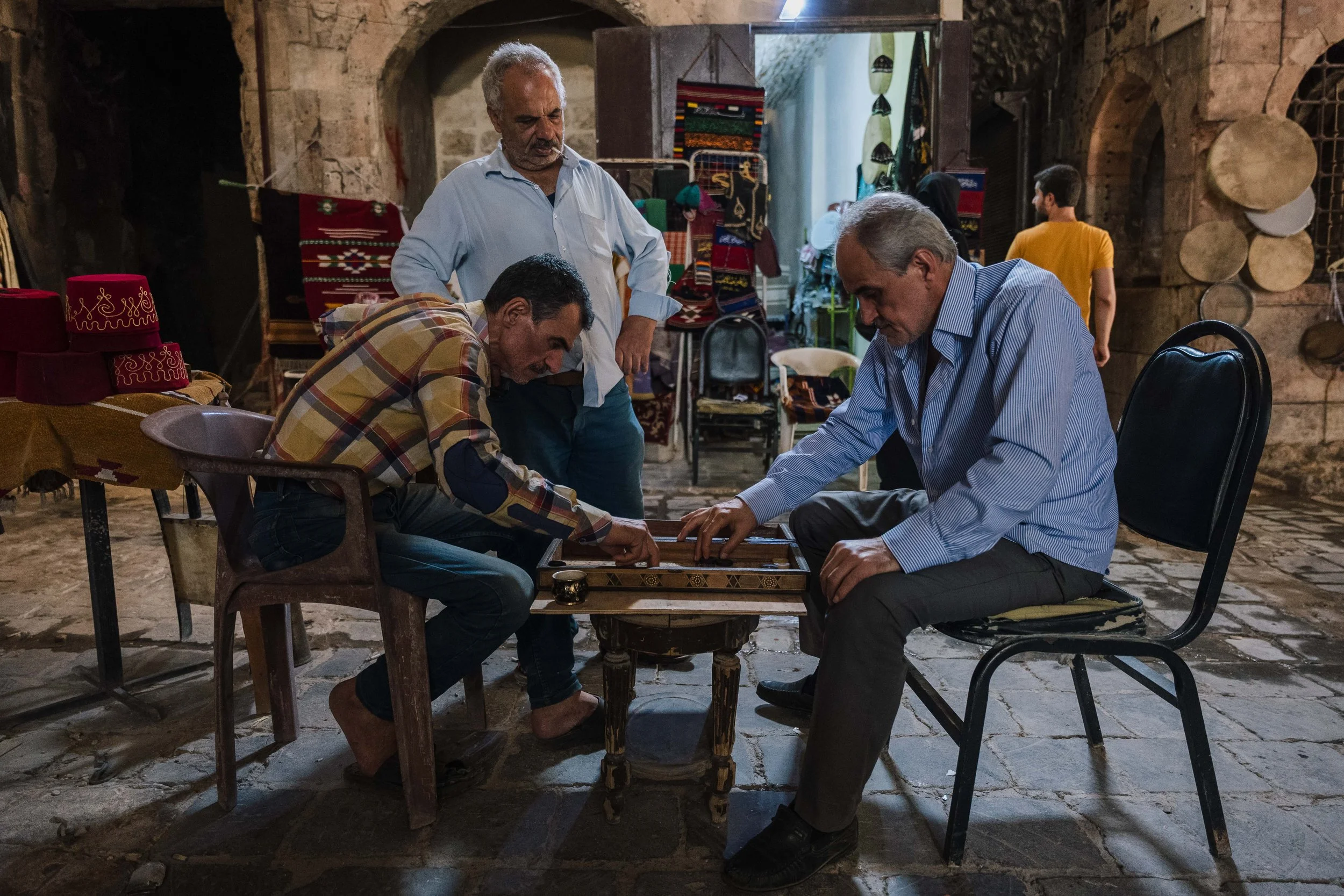 In the cool vaults of the souk, men play backgammon 