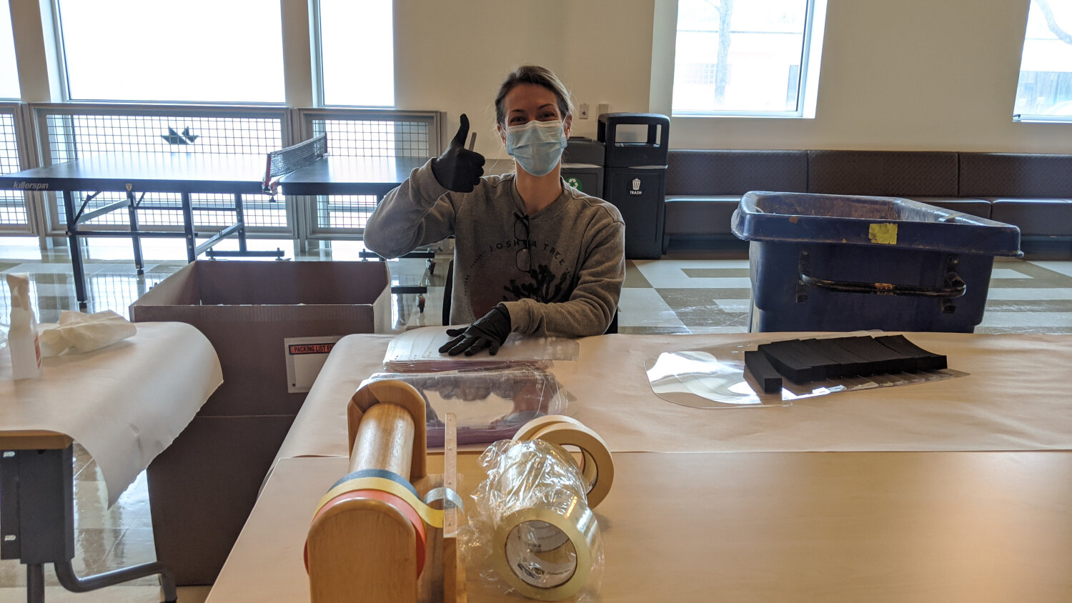  Volunteer at mHUB helping with face shield assembly. 