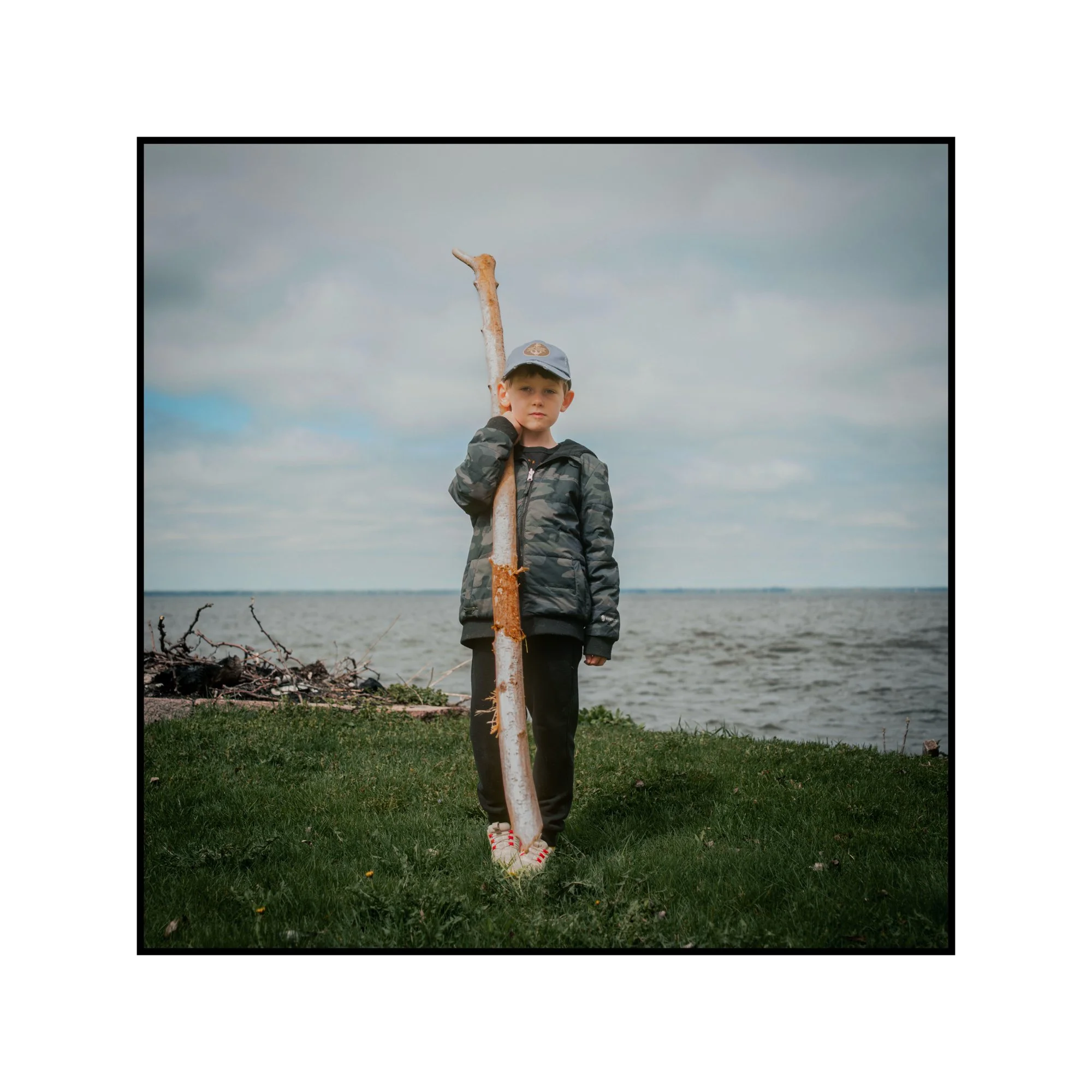 Evidence We Were Here: Waylon with driftwood, Lake Winnebago 2026. 