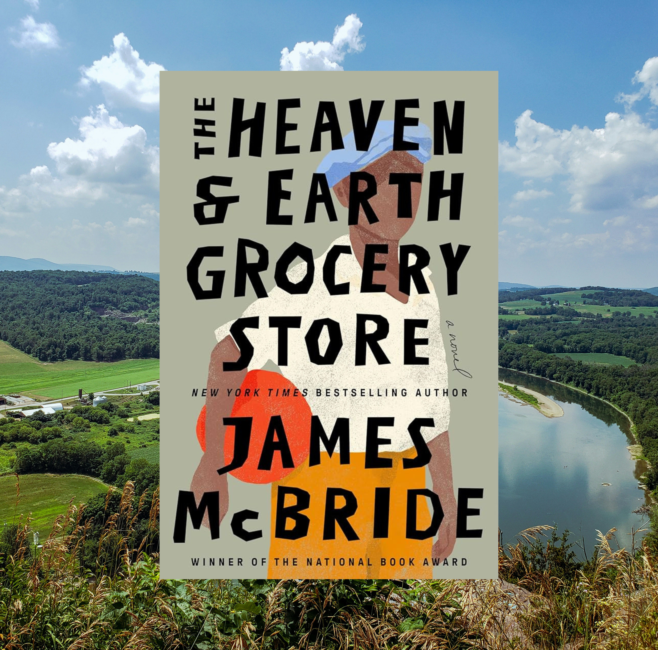 The cover of The Heaven & Earth Grocery Store by James McBride   on a background of a photo of a green landscape with a lake.