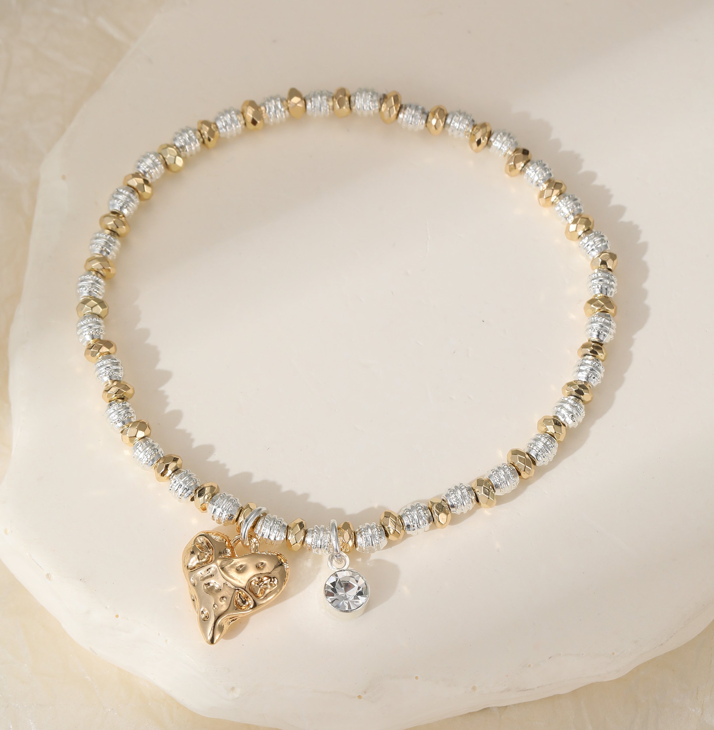 B302338SG.. Silver and gold heart charm bracelet