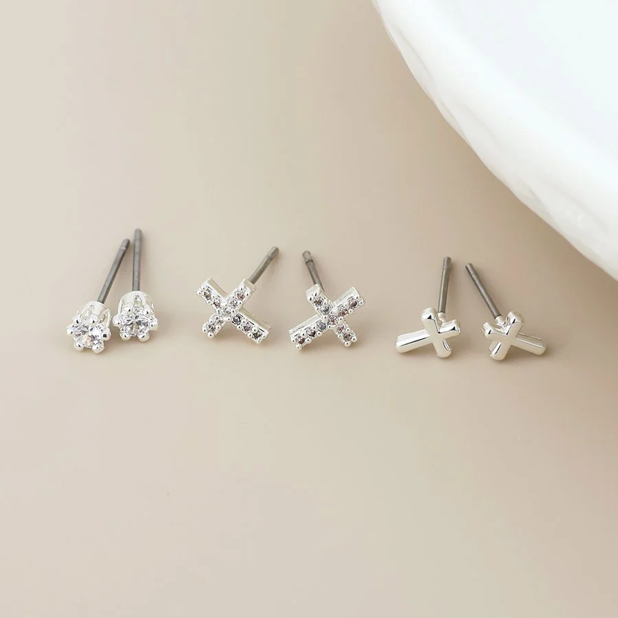 04959.  Set of three stud earrings by P.O.M.