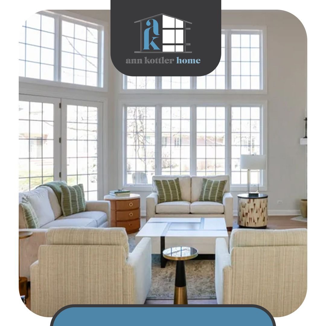 Spacious living room with large windows, neutral furnishings, natural light, and a thoughtfully designed open-concept layout.