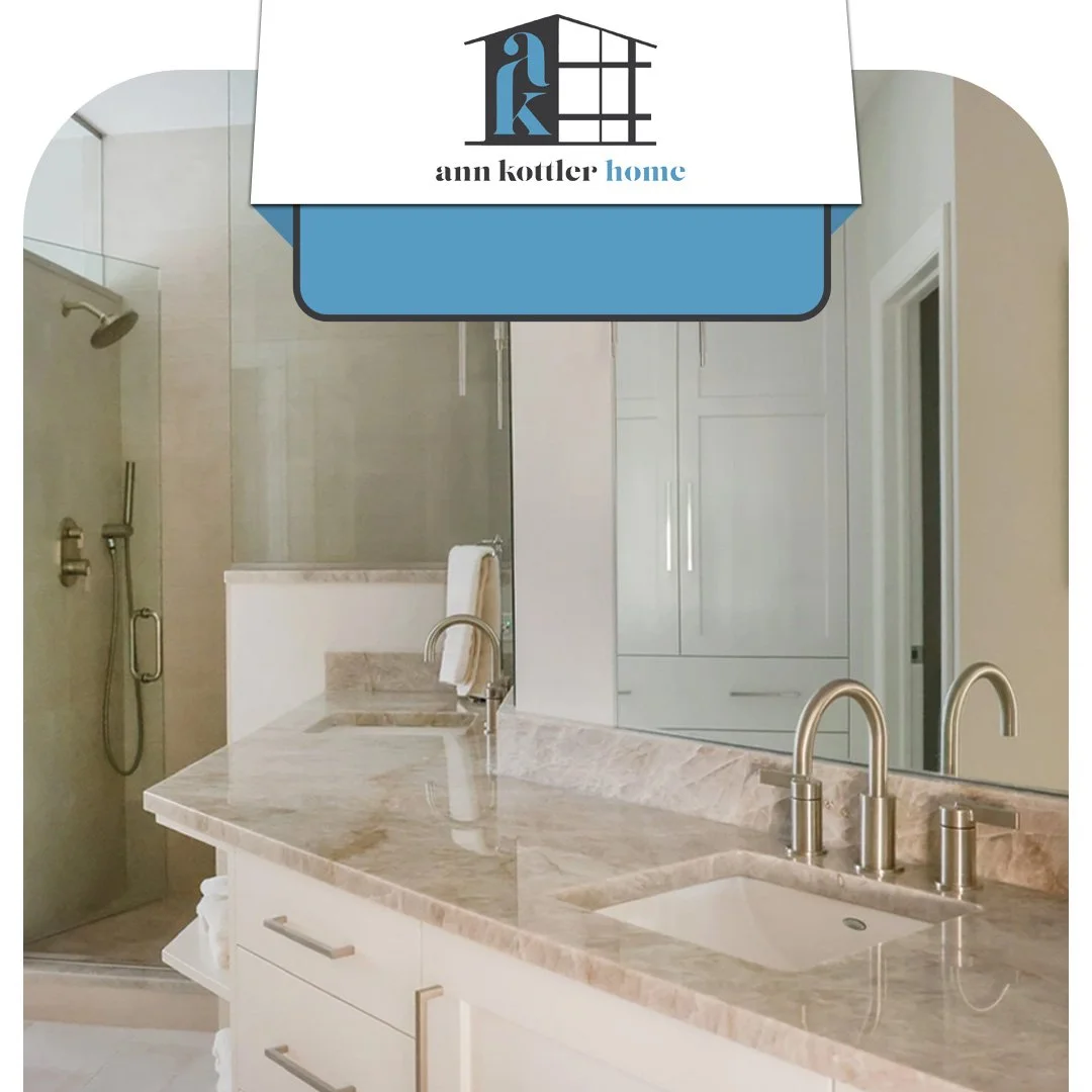 Elegant bathroom featuring a double vanity, marble countertops, and a glass walk-in shower.