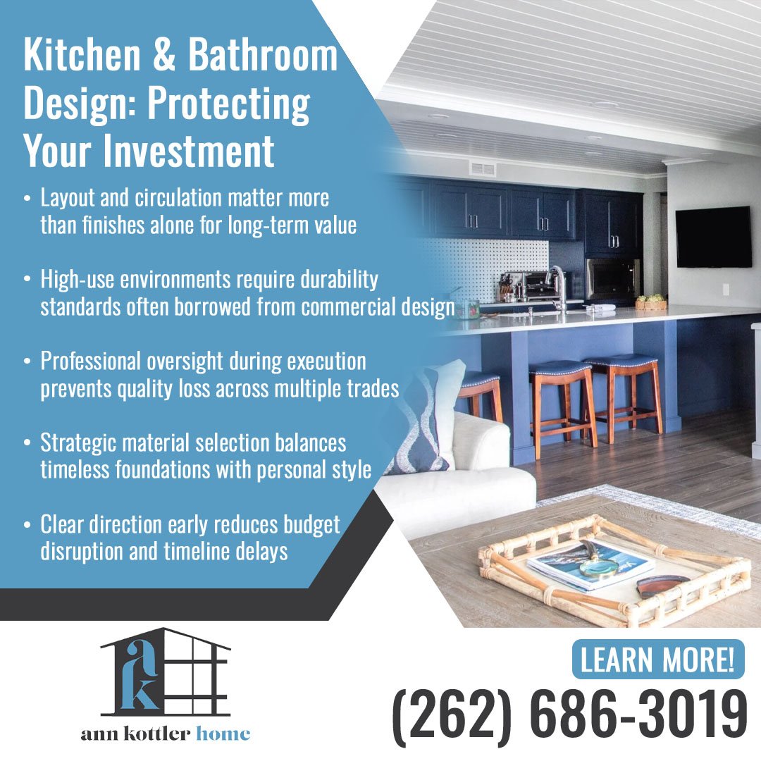 Modern open-concept kitchen with dark cabinetry, a large island, bar seating, and coordinated living space designed for functionality and lasting appeal.