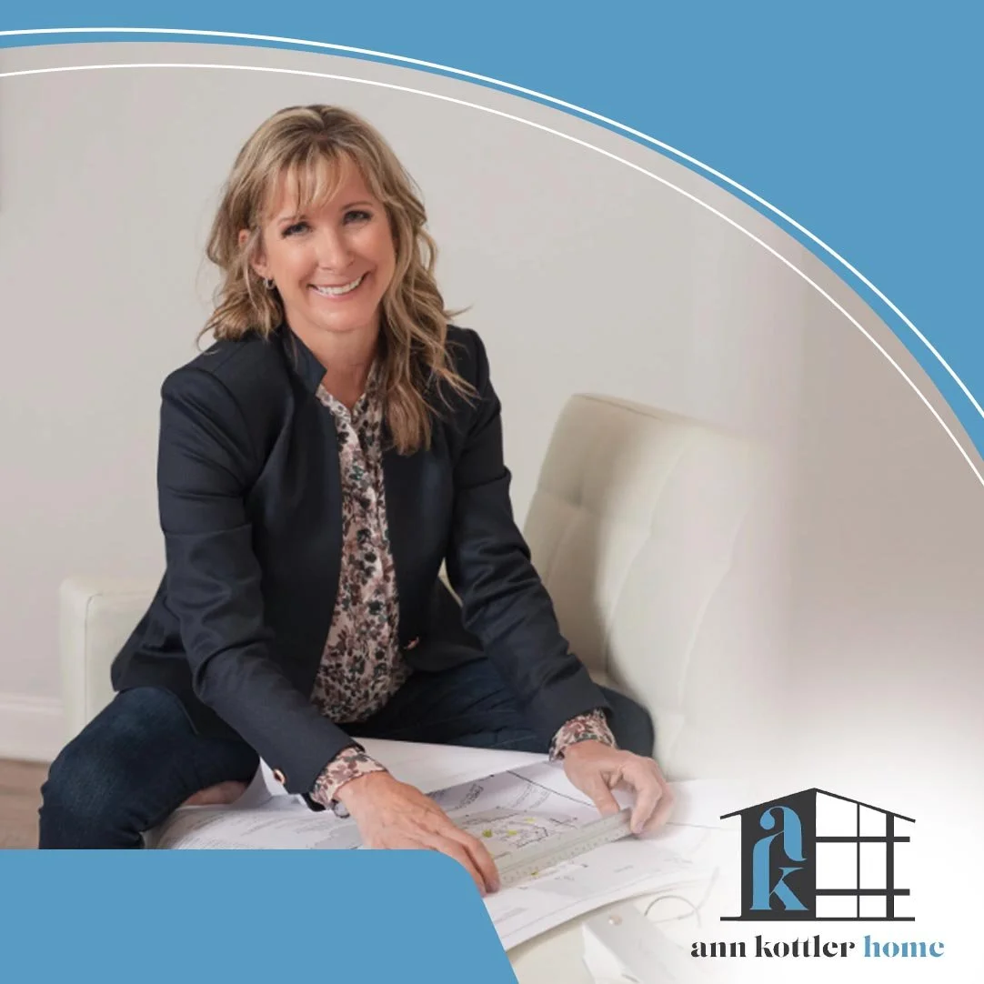 Professional interior designer reviewing architectural plans and design layouts during a residential renovation planning session.