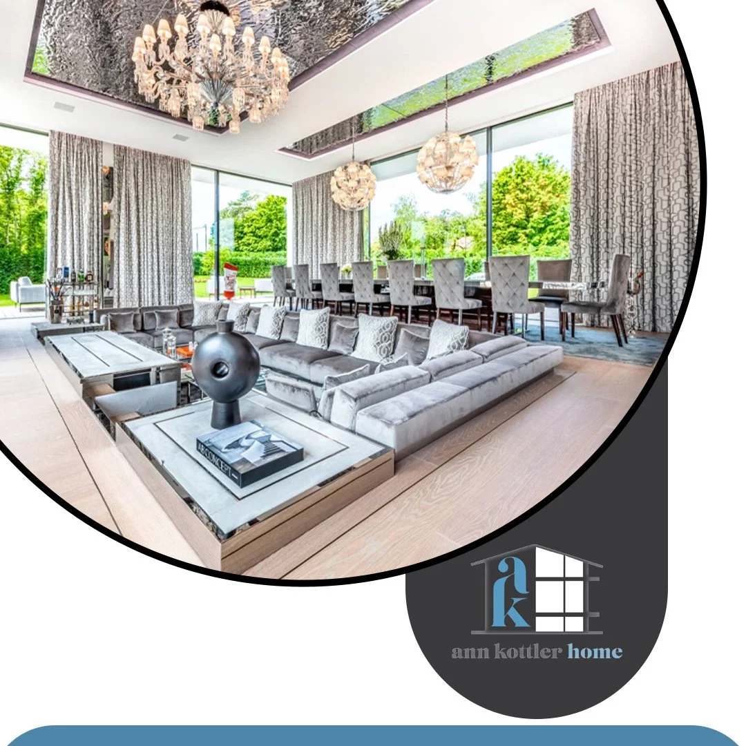 Elegant open-concept living and dining area featuring luxury furnishings, statement lighting, floor-to-ceiling windows, and sophisticated interior design.