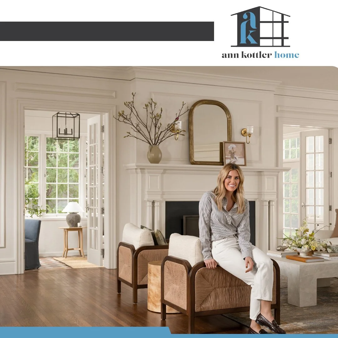 Interior designer in a sophisticated living room showcasing custom furnishings, architectural details, and a warm, inviting atmosphere.