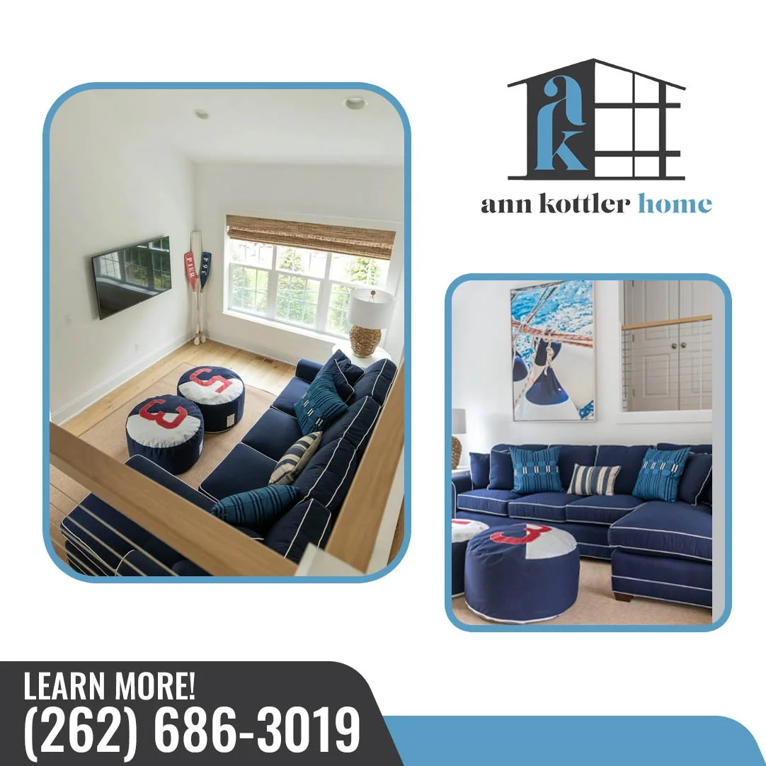 Navy blue sectional sofa with nautical ottomans and sailing artwork in a coastal-style living room
