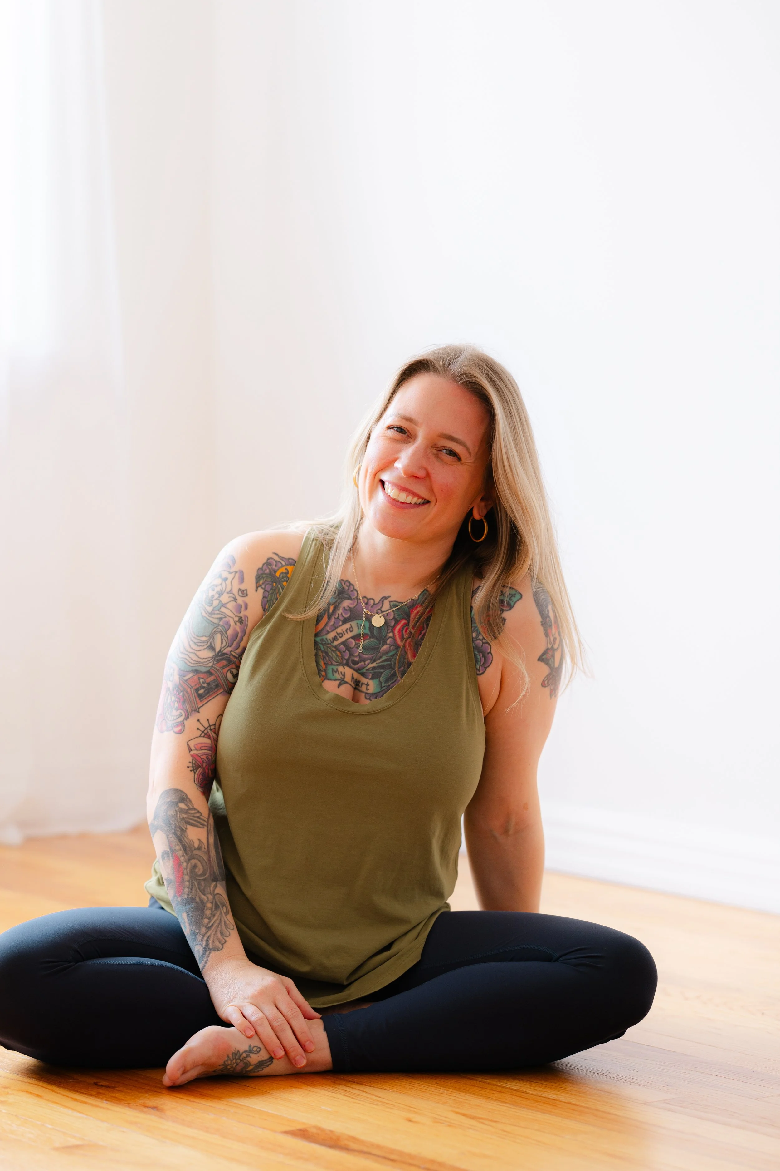 Lauren Reek private yoga teacher Long Island smiling seated cross legged