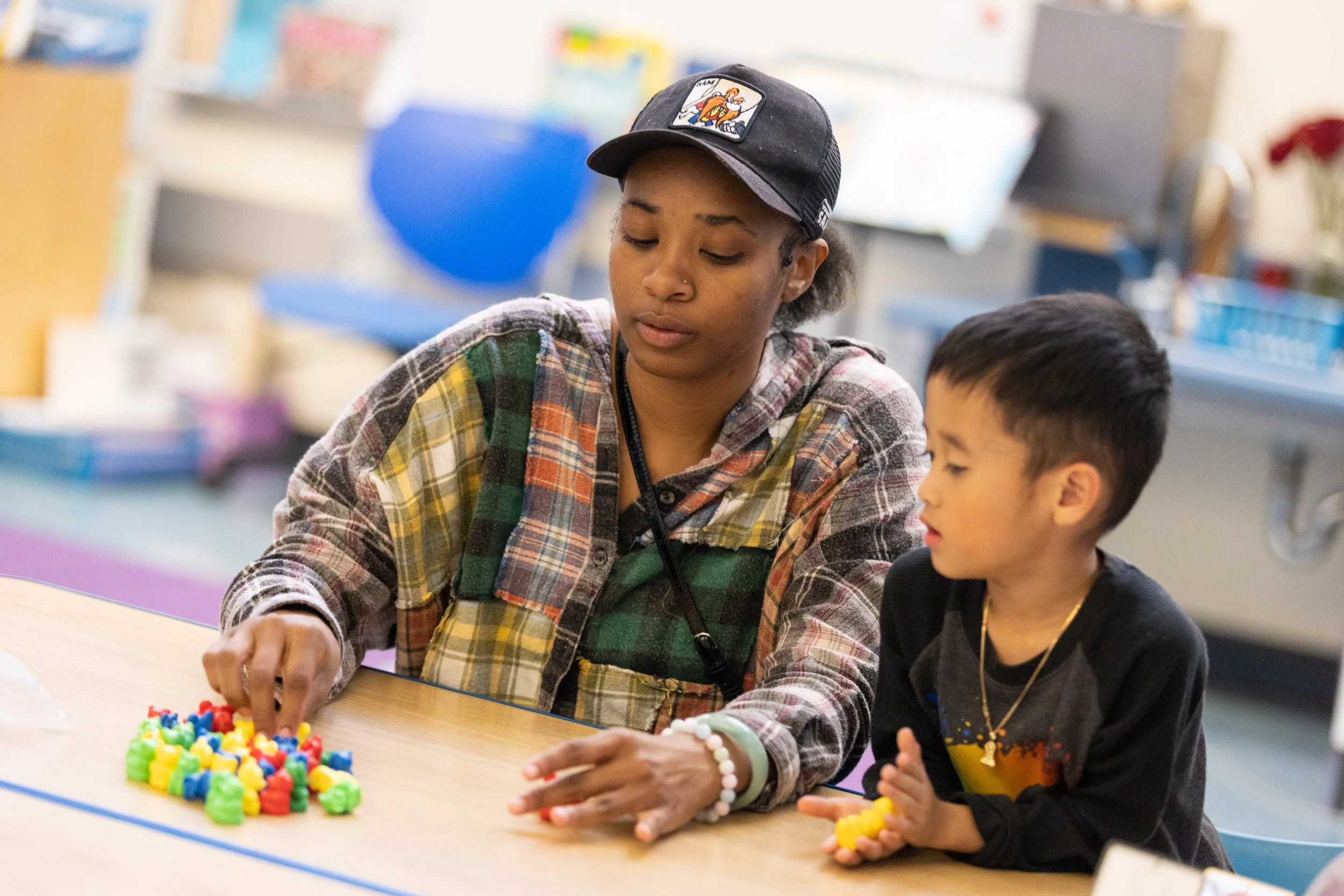 Teacher teaching young child sorting