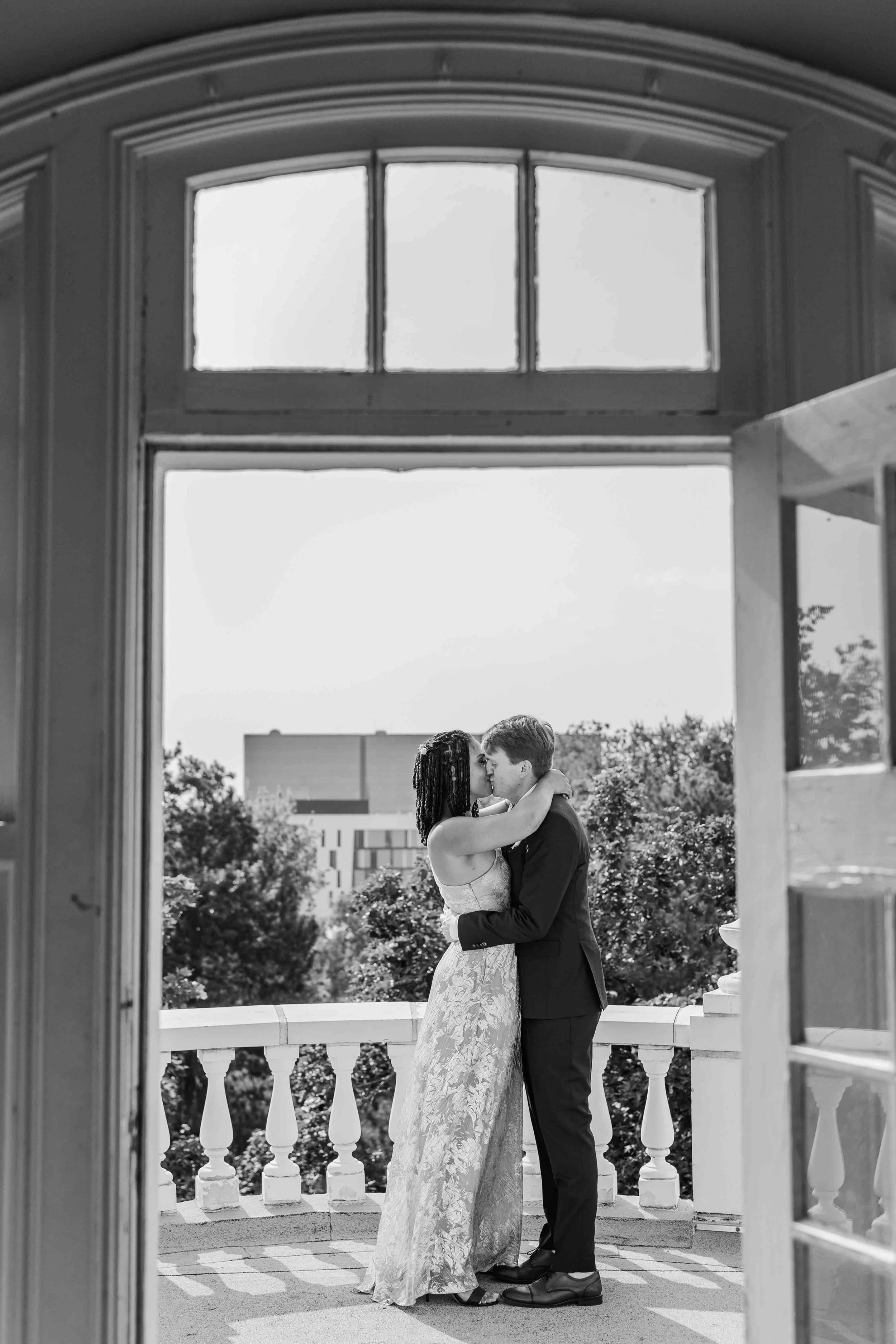 25-married-couple-kisses-on-terrace-colorado-mansion-wedding-venue.jpg