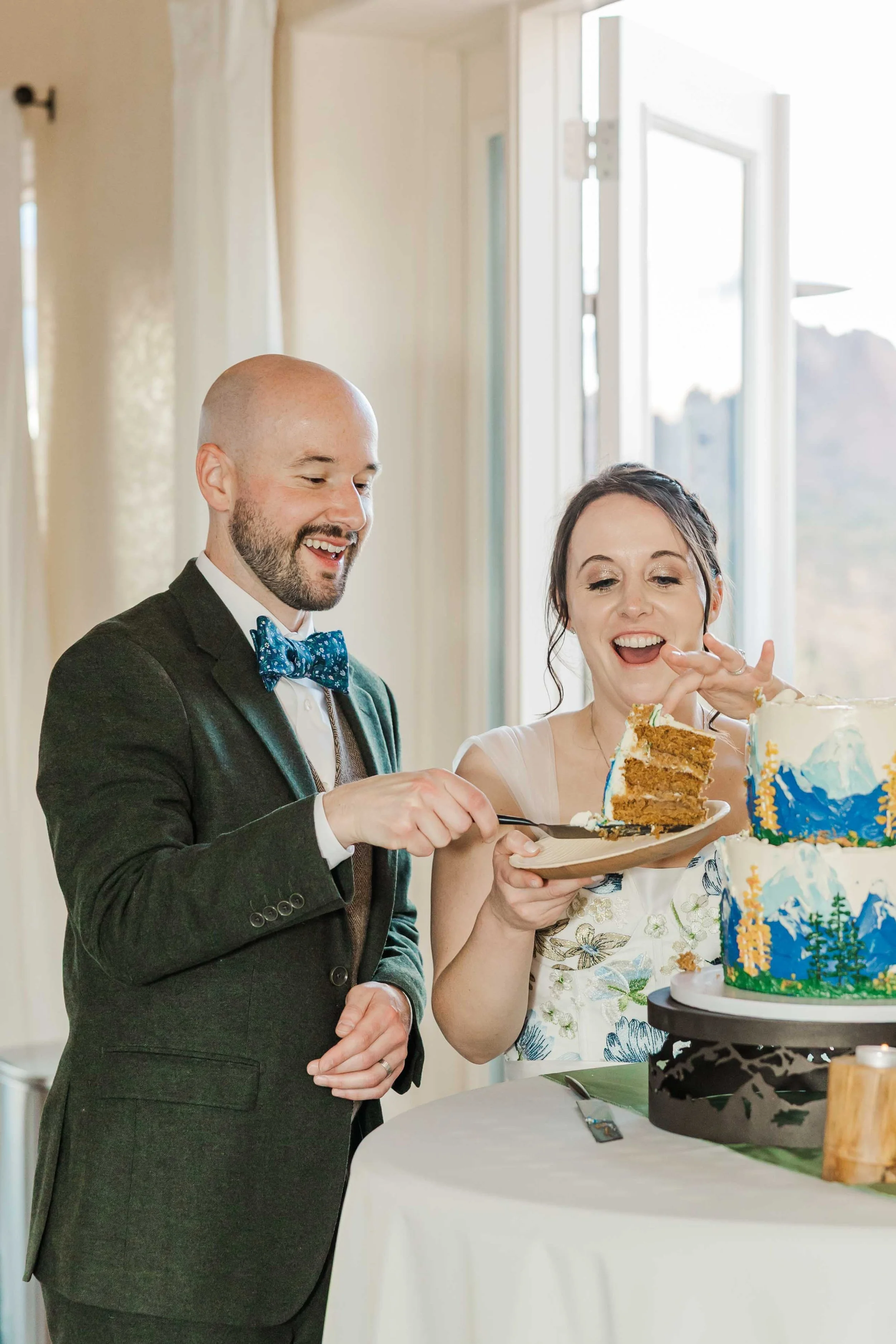 43_colorado-wedding-couple-cuts-cake-pikes-peak-ranch.jpg