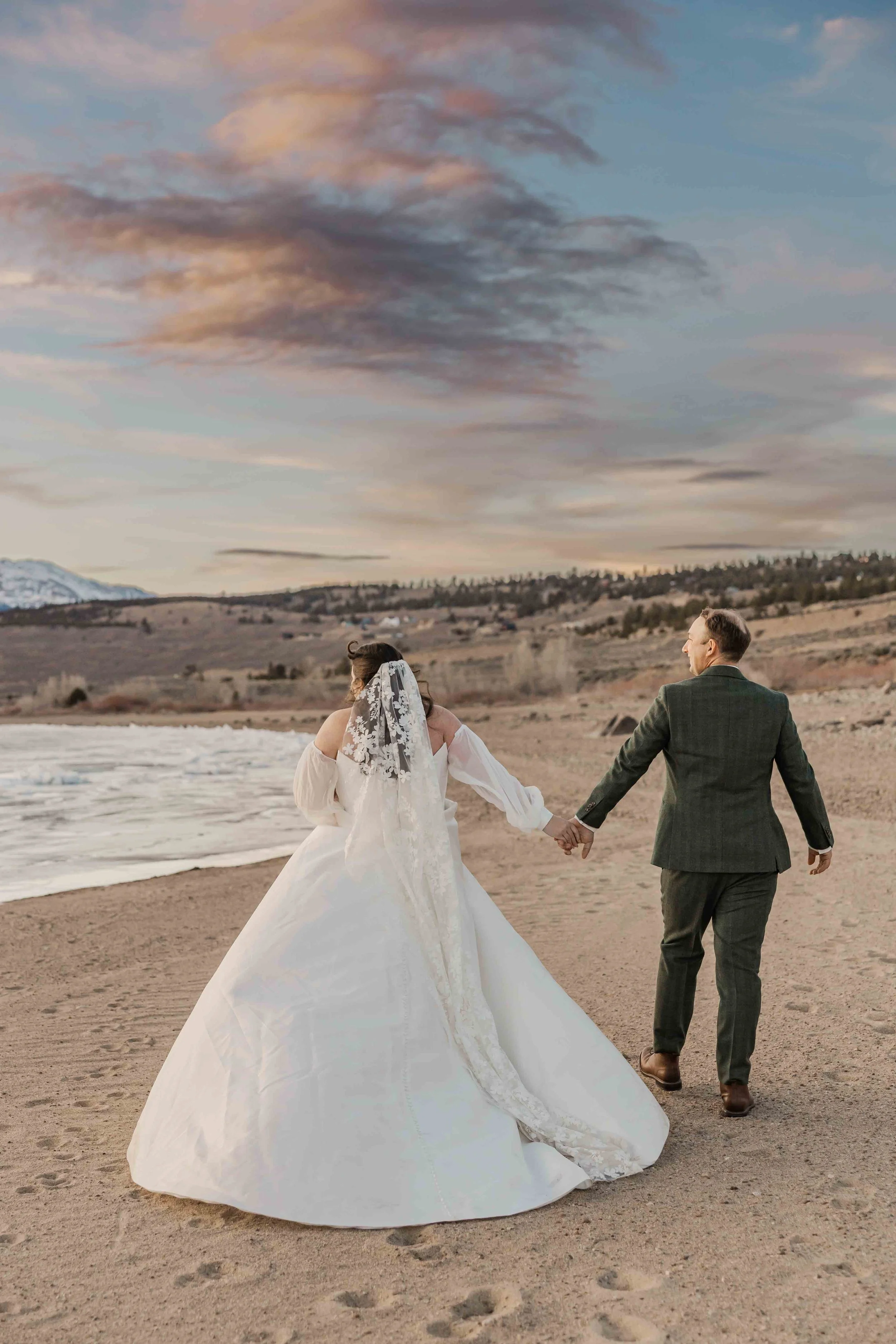 66_bride-and-groom-walk-beach-in-colorado.jpg