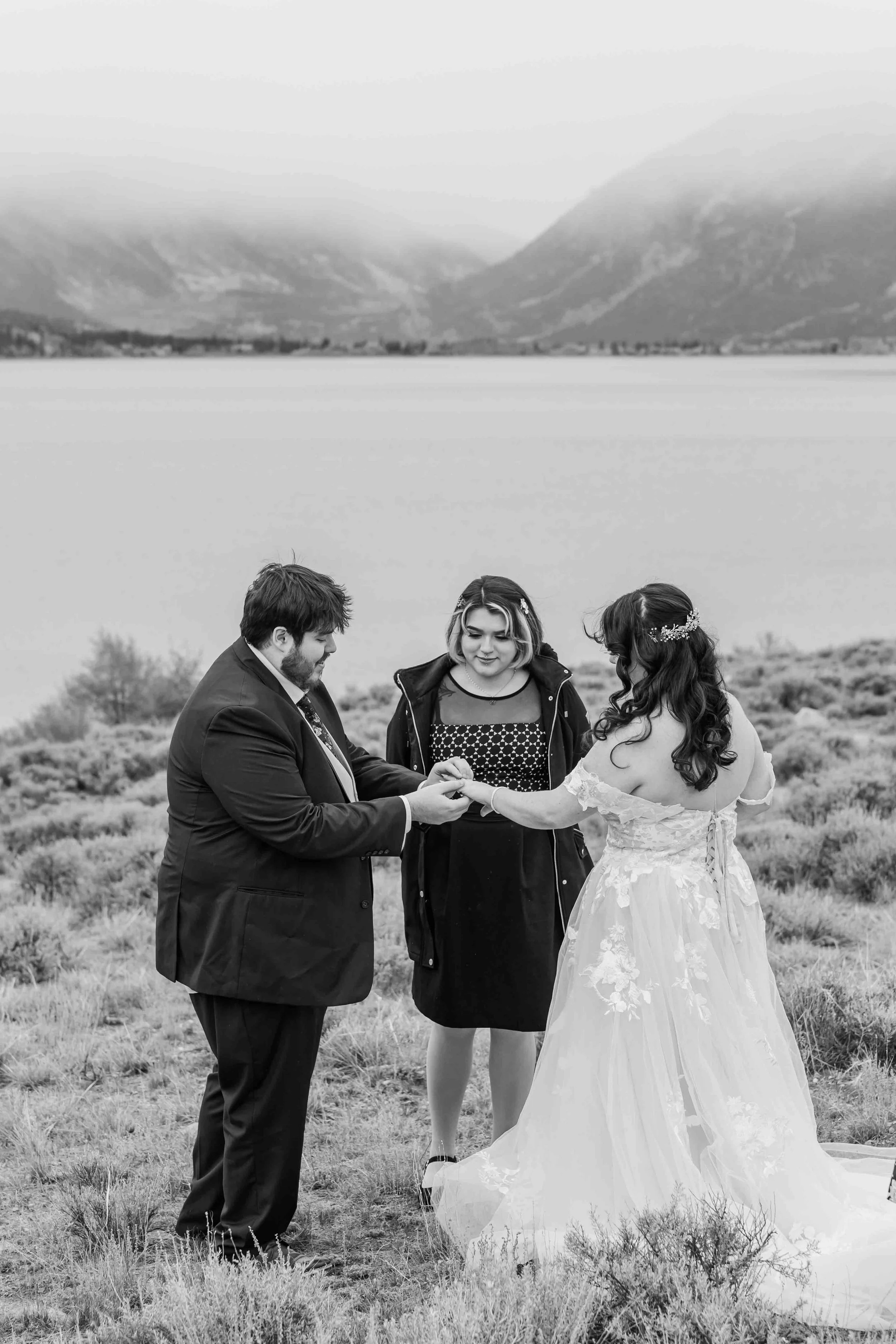 10-colorado-elopement-ceremony-bride-and-groom-exchange-rings.jpg
