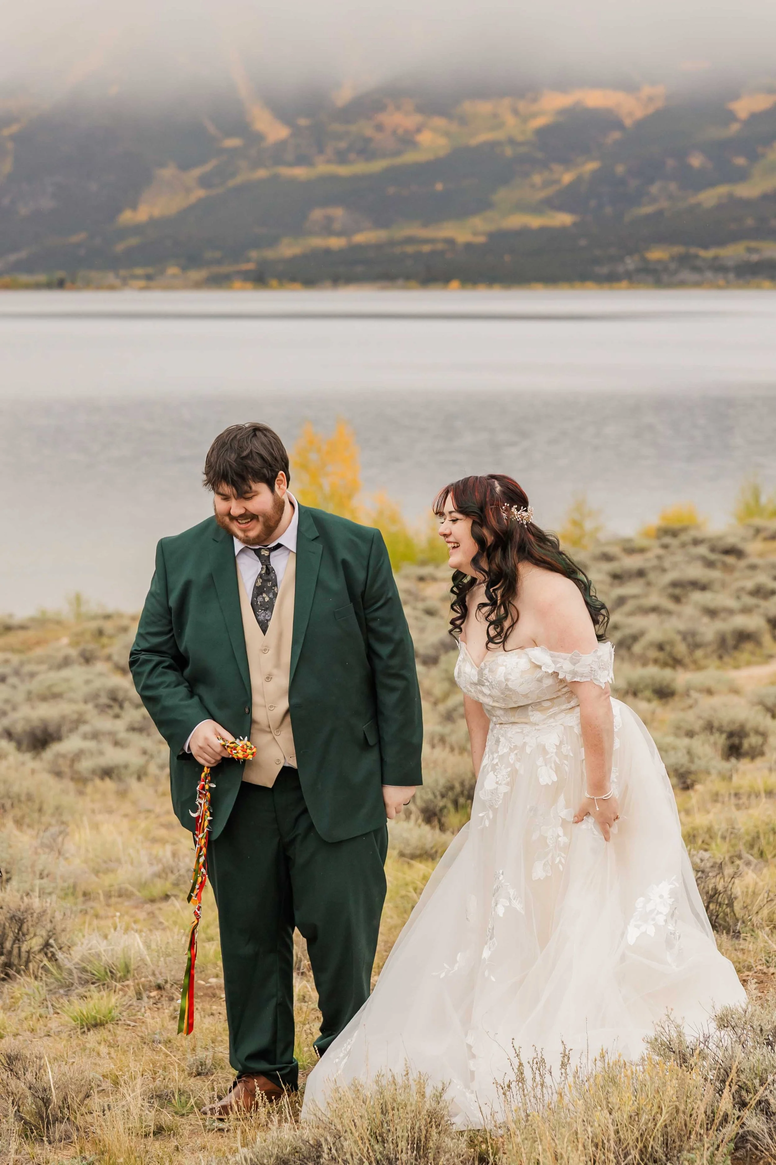 13-documentary-style-photography-bride-and-groom-laugh-following-wedding-ceremony-outside-in-colorado.jpg
