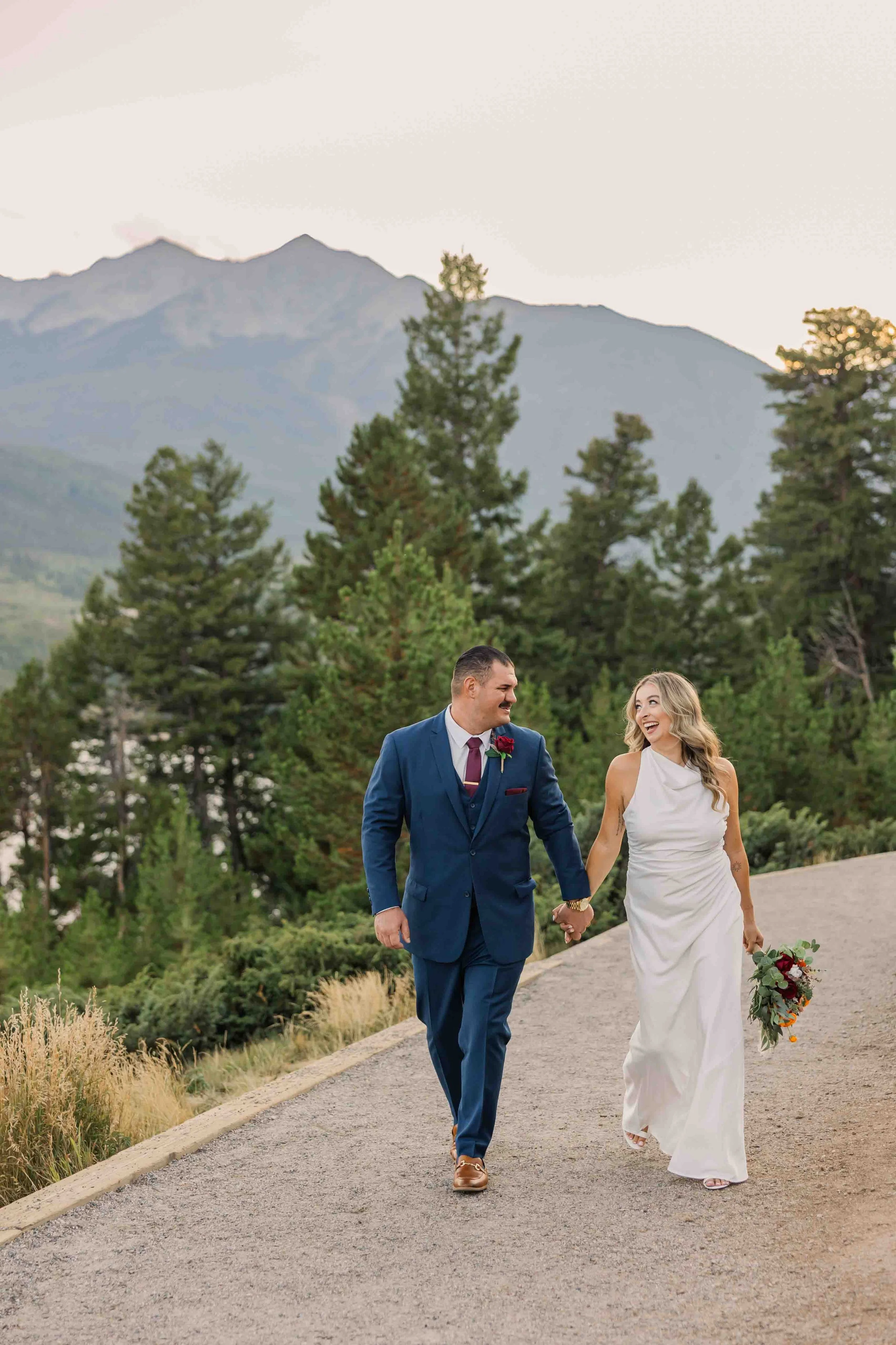 26_bride-and-groom-walk-towards-camera-colorado-wedding.jpg