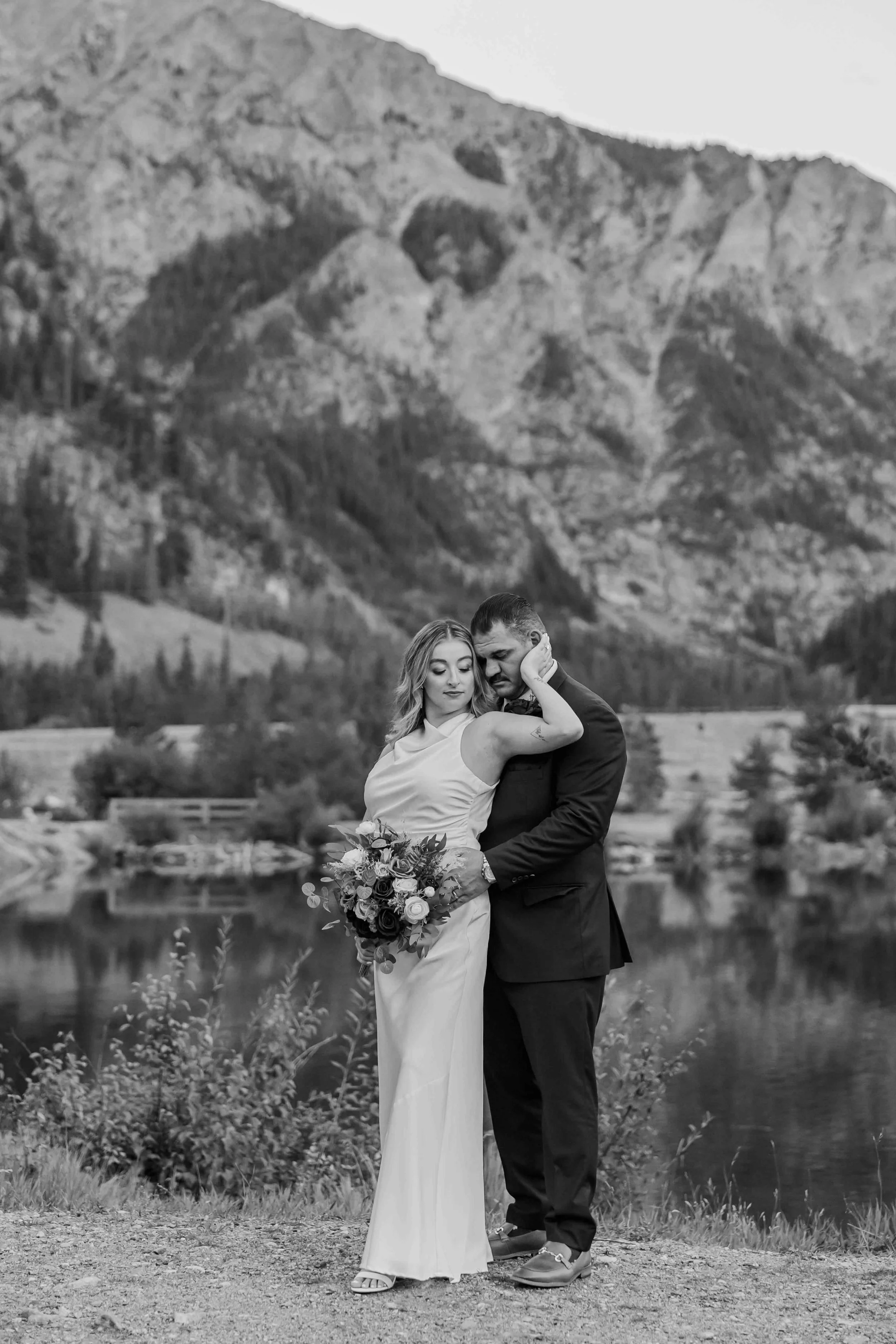 45_bride-and-groom-pose-overlooking-lake-on-sapphire-point.jpg