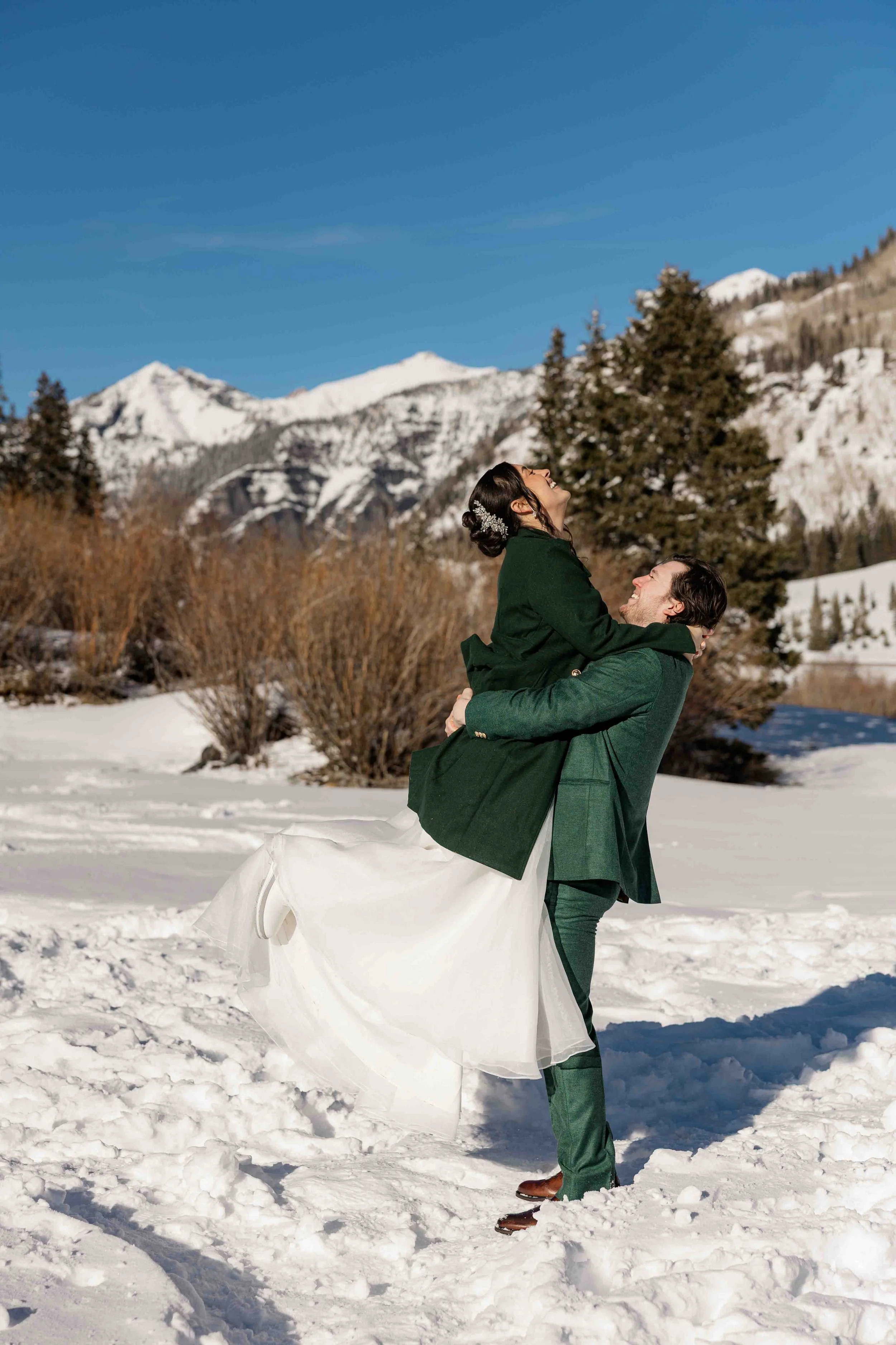 38_groom-lifts-bride-in-green-wedding-coat-during-elopement-in-ouray-colorado.jpg
