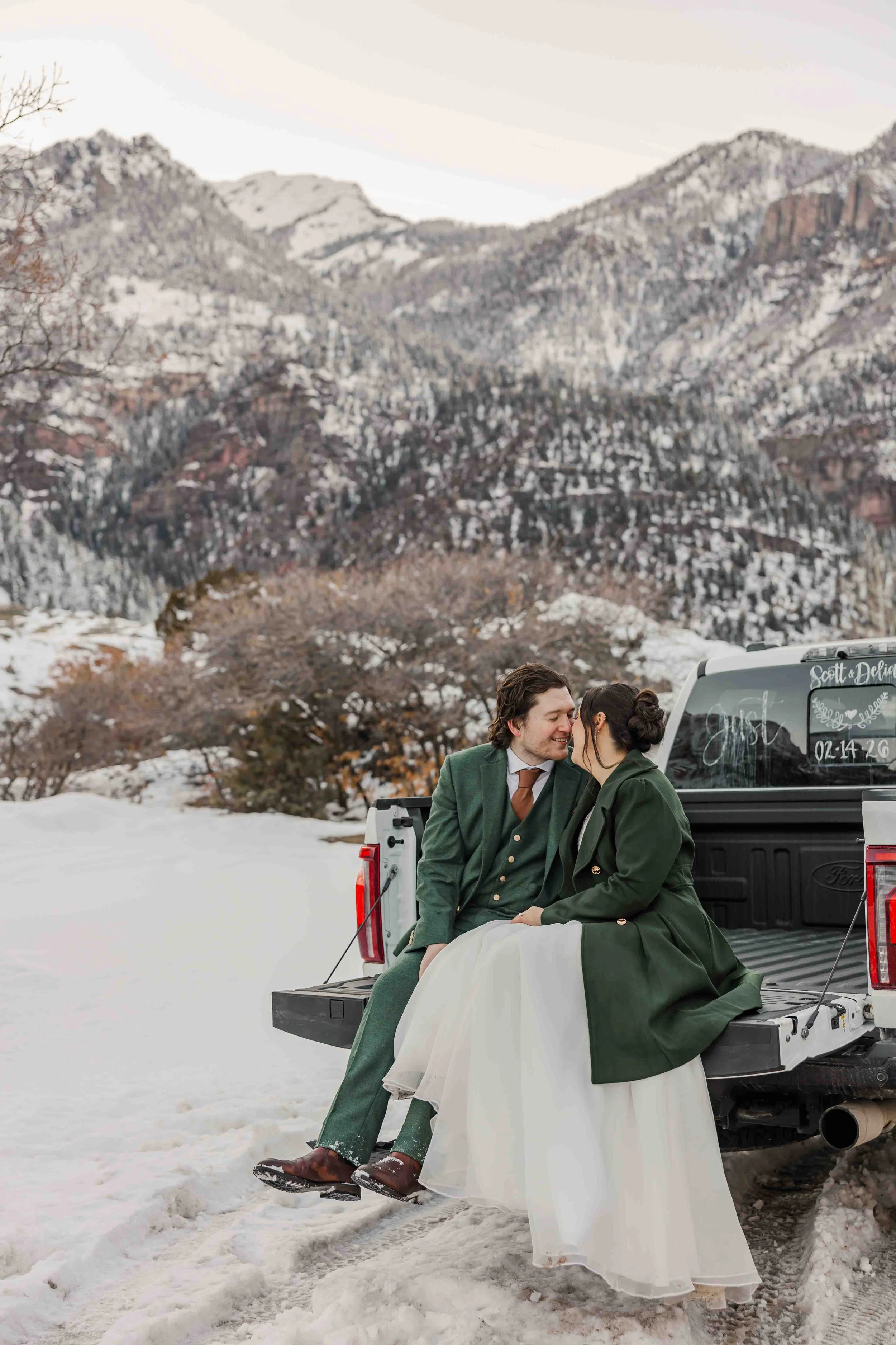 59_winter-elopement-in-san-juan-mountains-bride-and-groom-sit-on-truck-bed.jpg