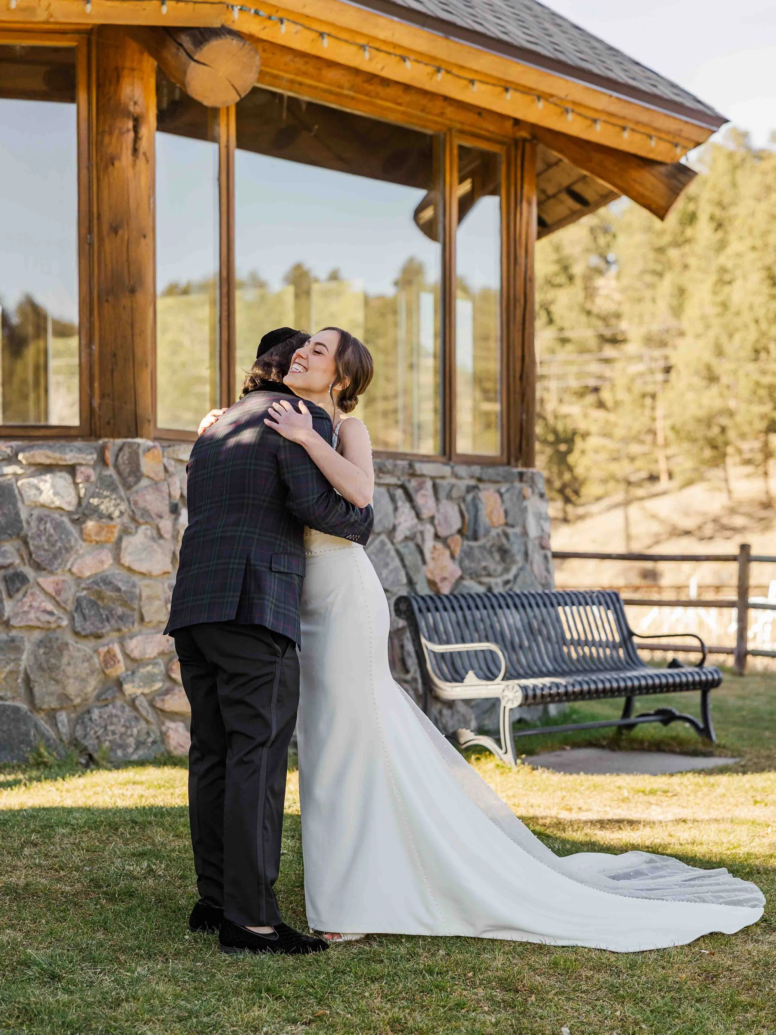 06_bride-and-groom-embrace-outside-evergreen-lakehouse.jpg