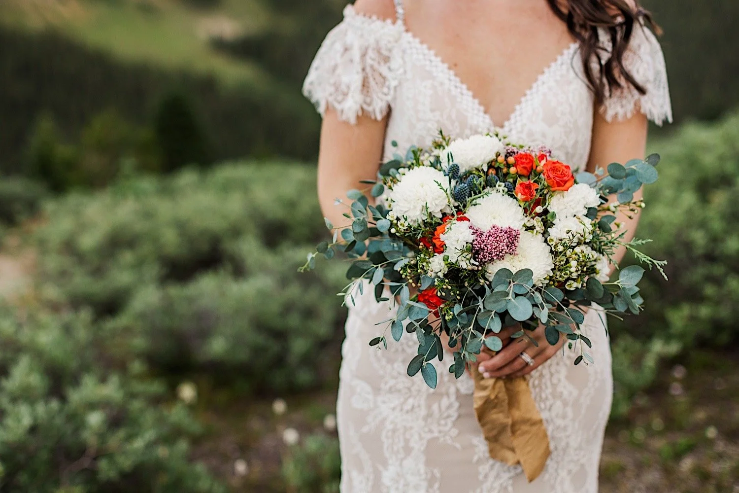 Closeup photo of a bride holding her bouquet