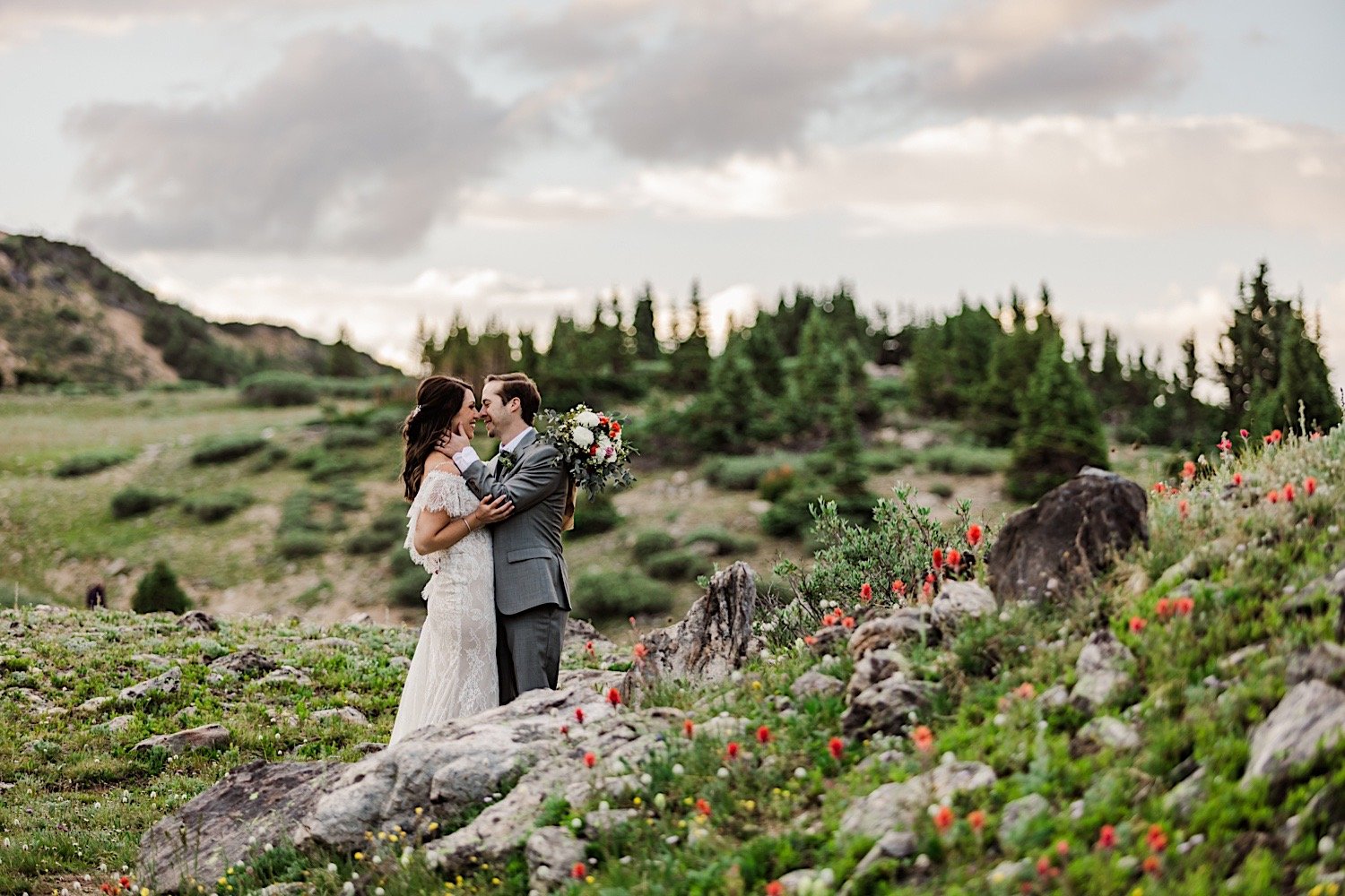 A bride and groom smile as they're about to kiss after their elopement in the mountains of Dillon Colorado