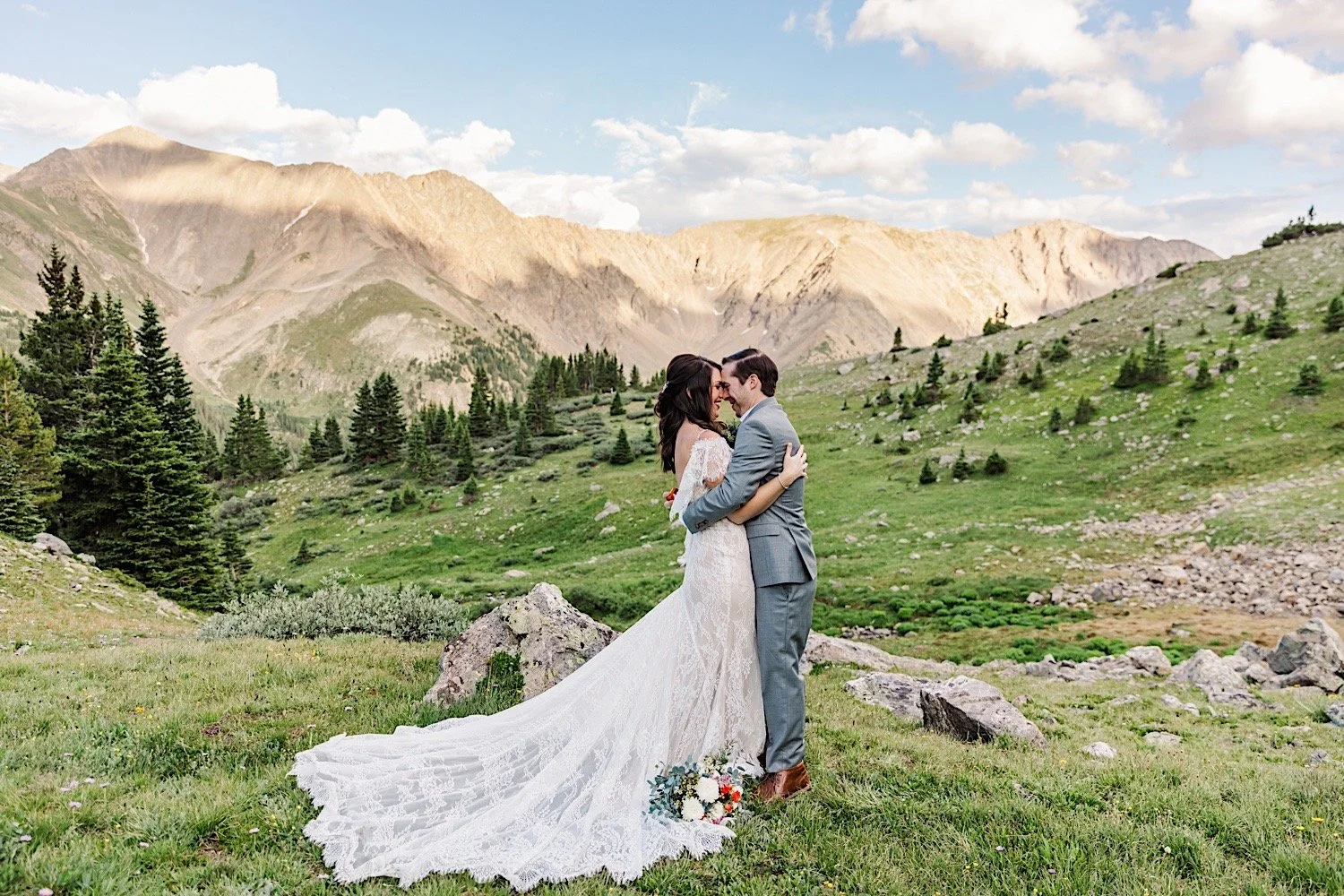 A bride and groom embrace and smile after their elopement ceremony in the mountains of Dillon Colorado