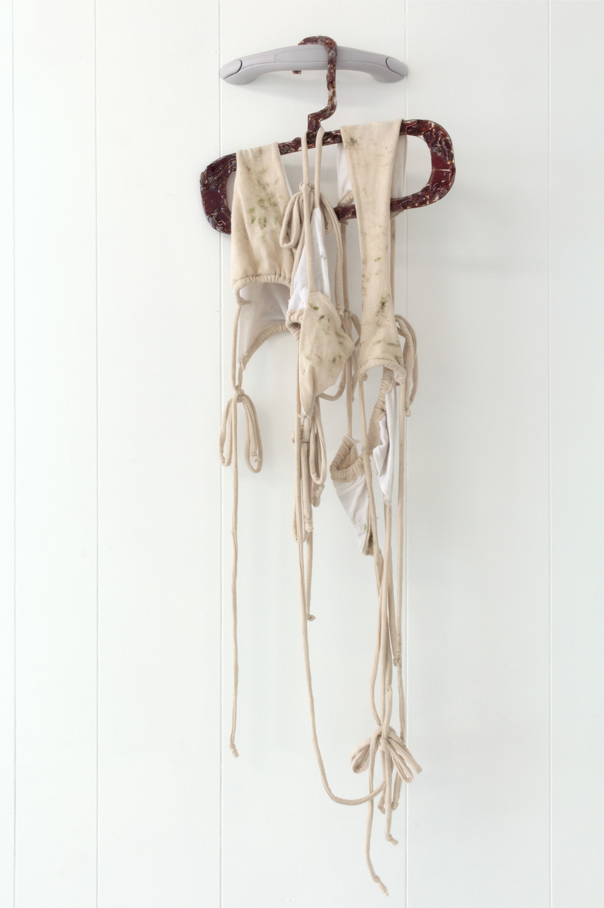  Maeve Coughlin  Untitled (airdry) , 2022 Vinyl car grab handle, Jack Links jerky, resin, cotton jersey, grass, dirt, and lake water Dimensions variable 