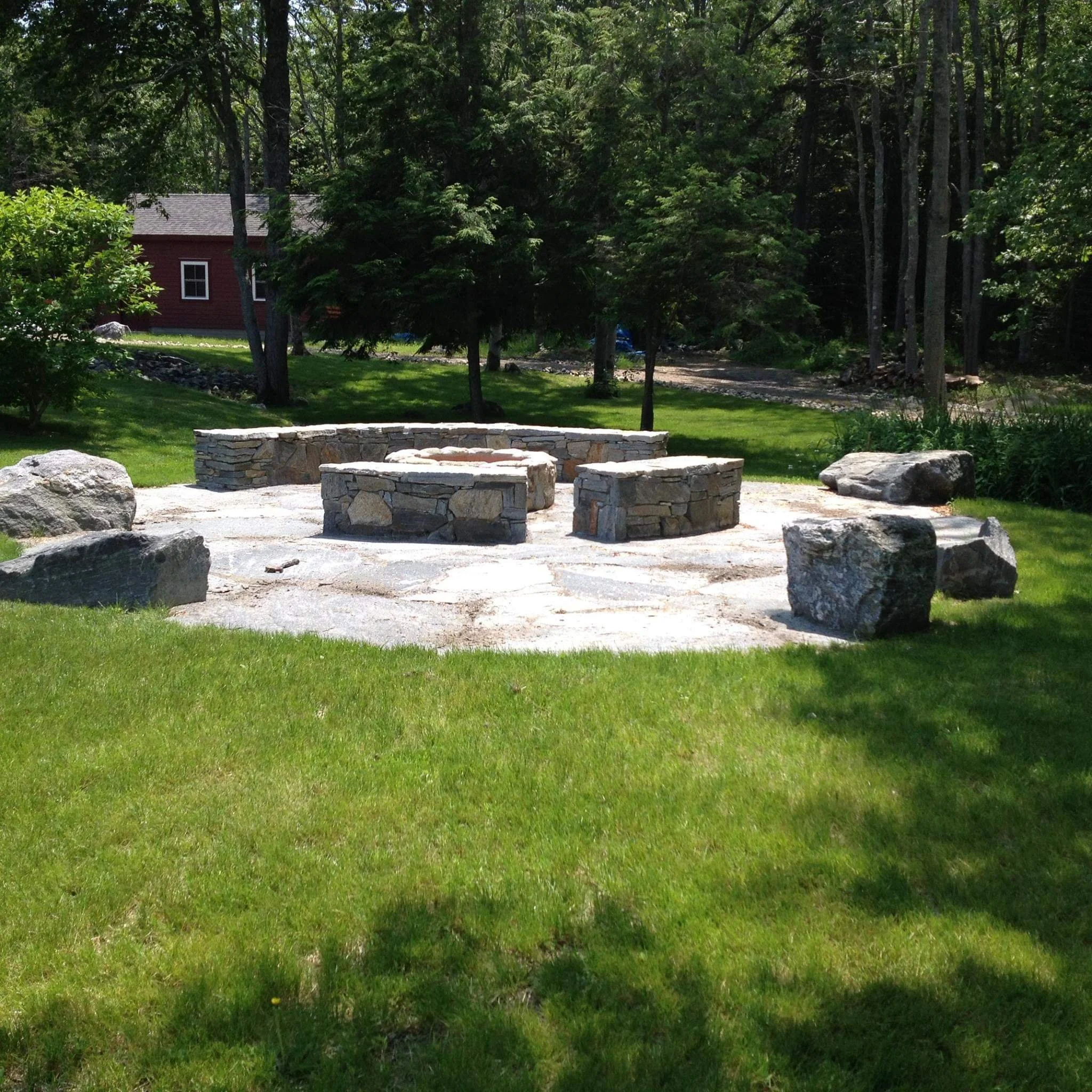 stone patio with fire pit and stone wall benches