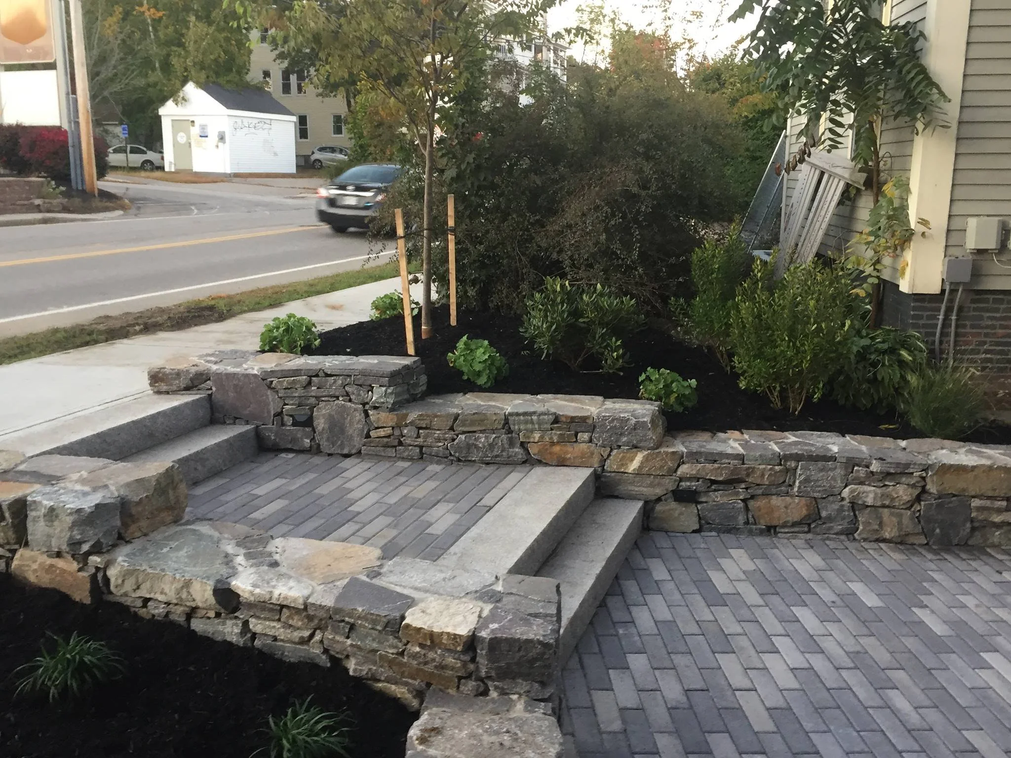 Hardscape stone and paved walk way with stone wall