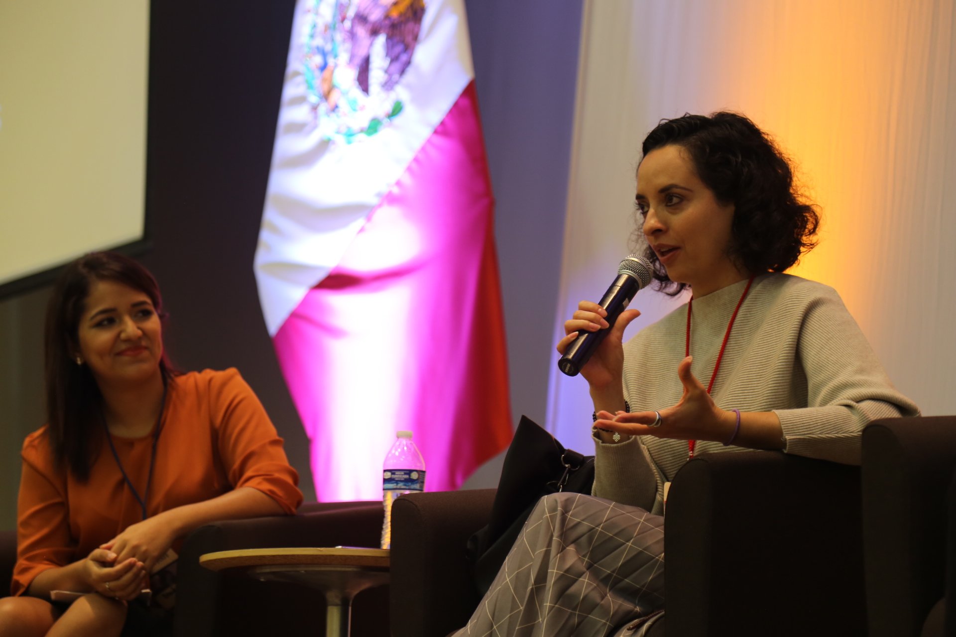 Greta Rios sitting down, speaking into a microphone