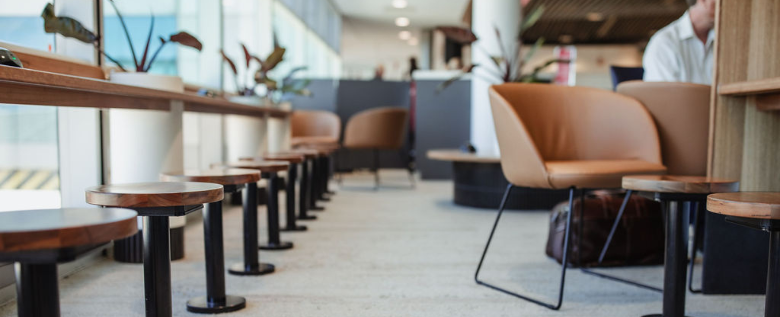 Modern airport lounge with wooden stools and brown chairs airport retail Interior Designers in Brisbane Australia