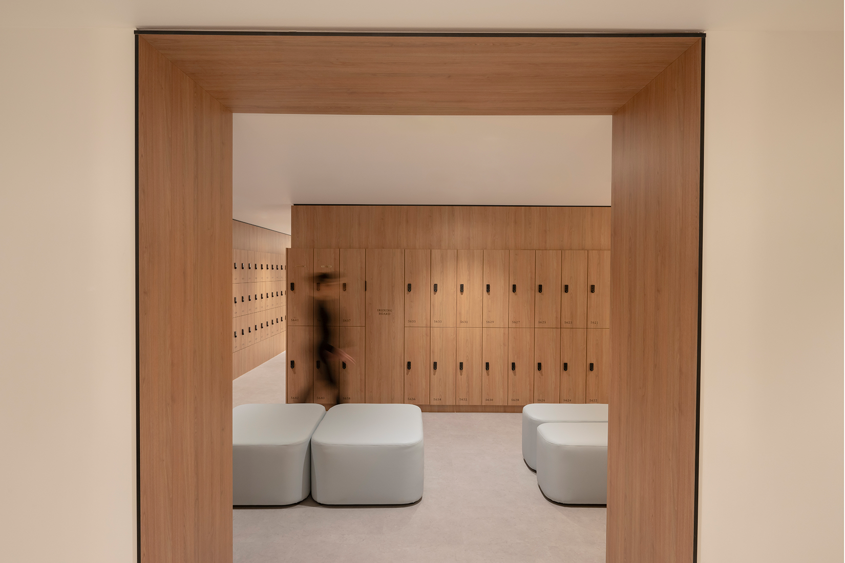 Tattersall's Club. Modern locker room with wooden lockers and light-colored seats. Hospitality Interior Design Brisbane Australia