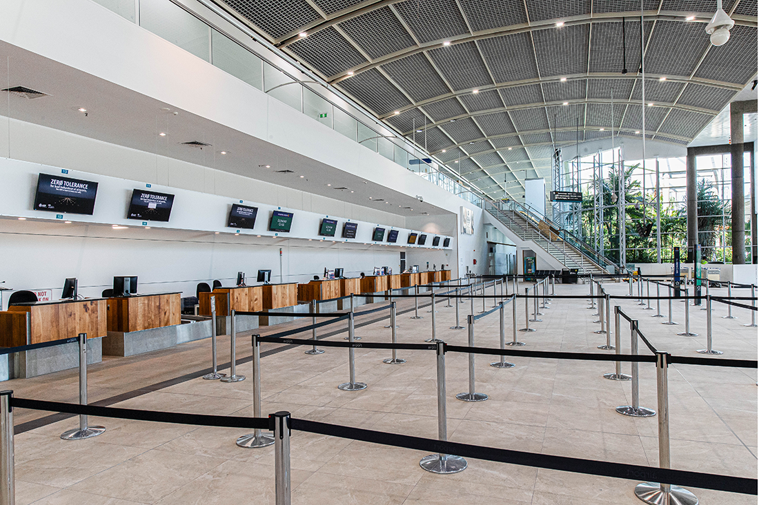Cairns International T1 Airport. Interior of an airport check-in area with counters and empty queue lines. Airport Interior Design Brisbane Australia