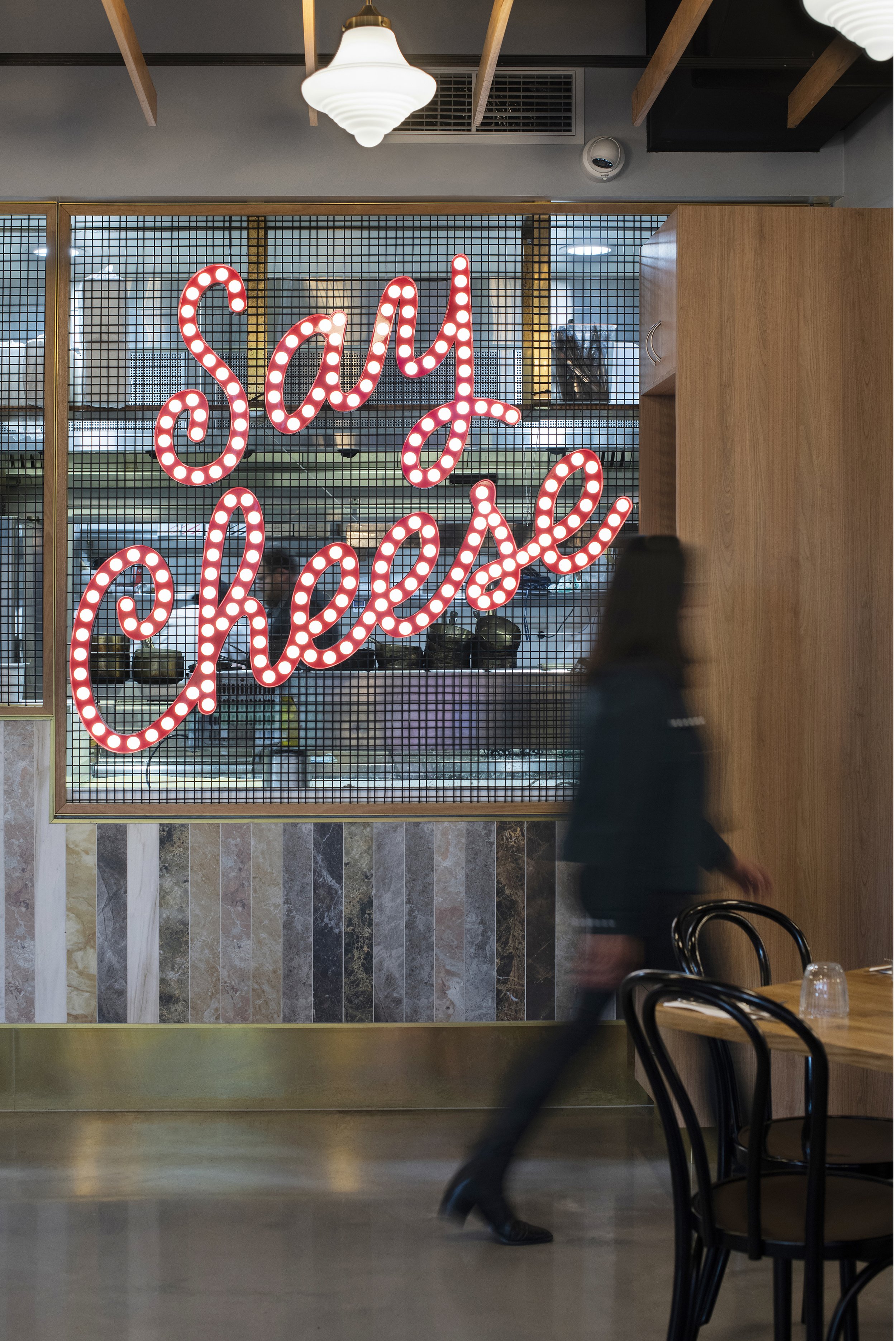 Restaurant interior with wall sign saying "Say Cheese."