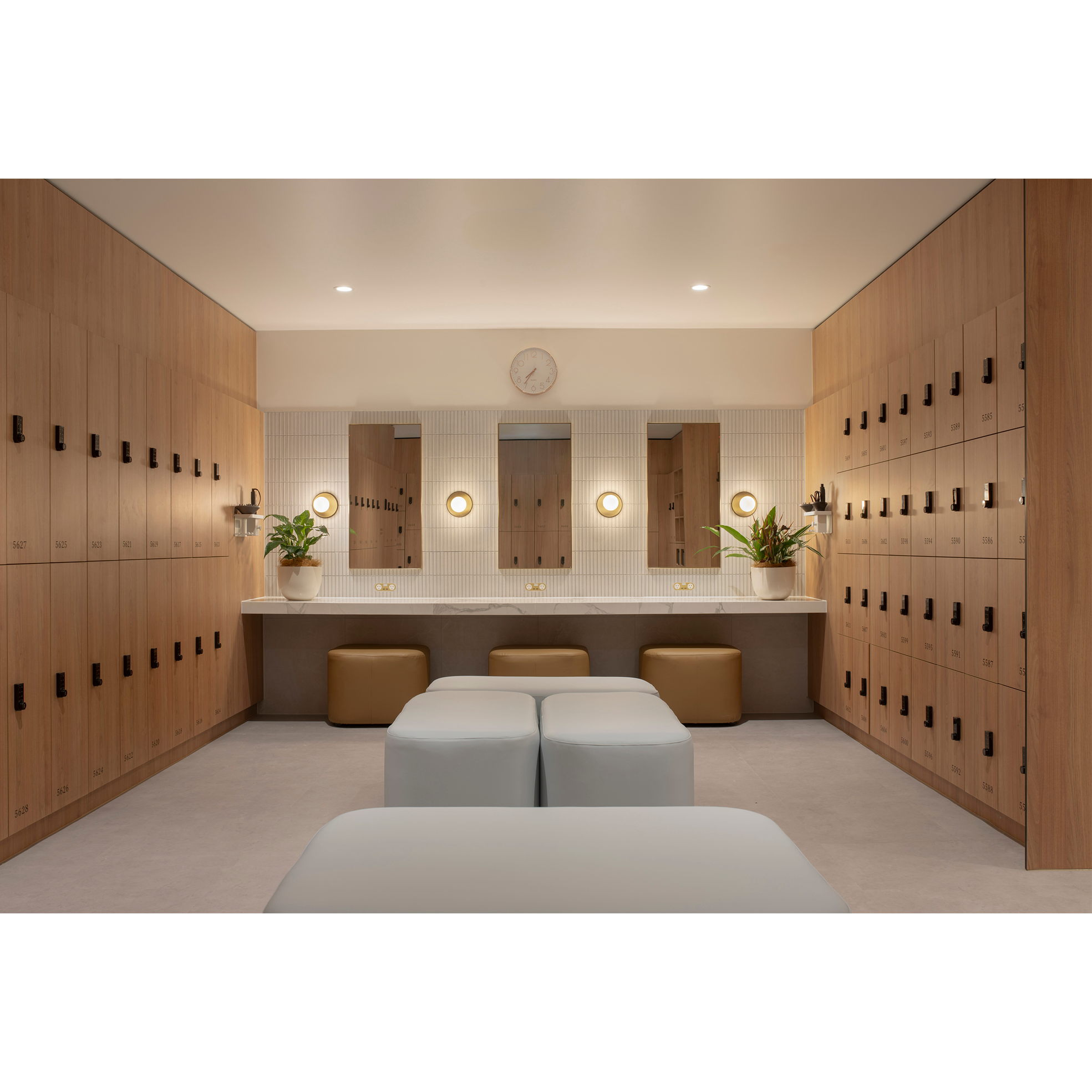 Modern locker room with wooden lockers, mirrors, sinks, poufs, and potted plants. Hospitality and Hotel  Interior Designers in Brisbane Australia