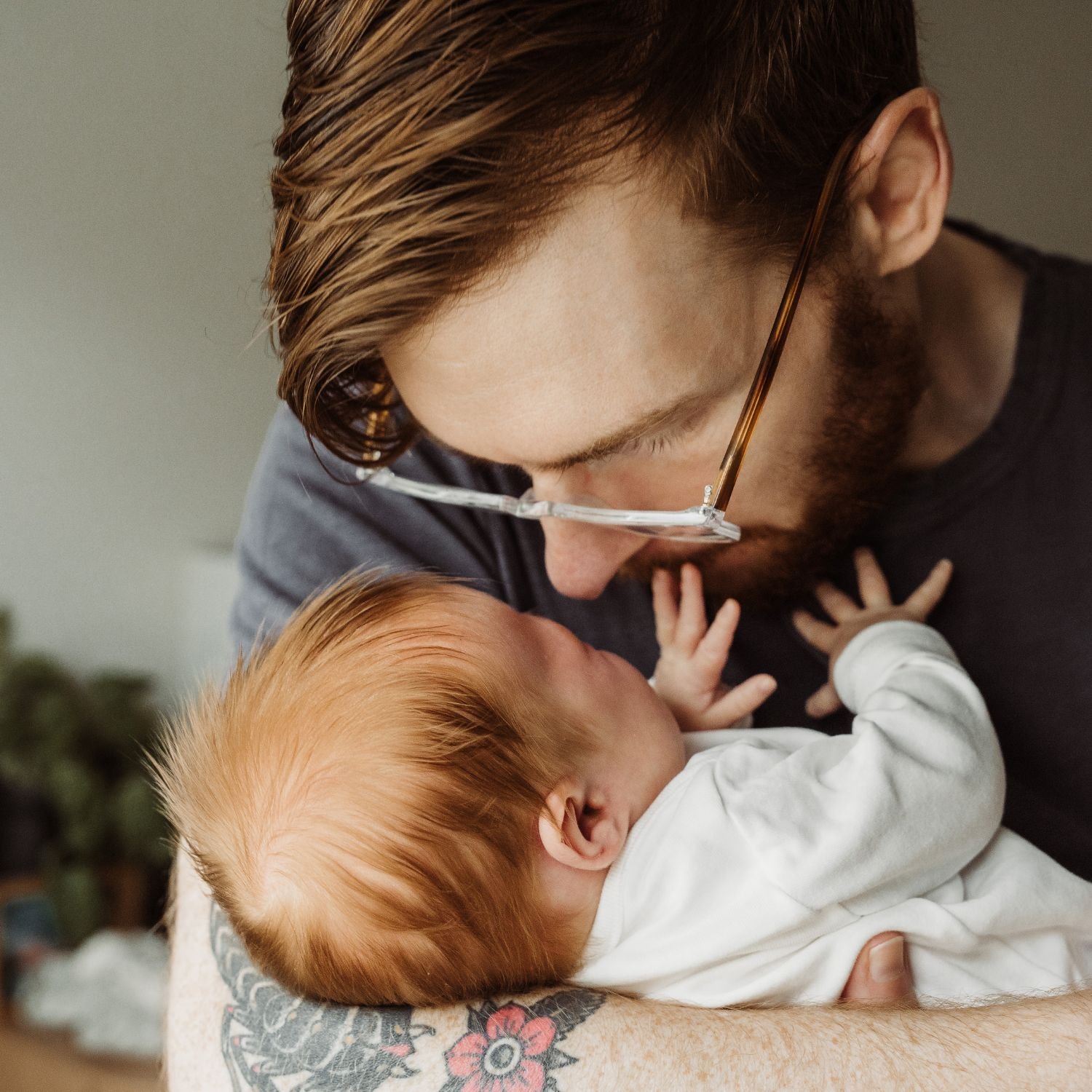 Father snuggles newborn