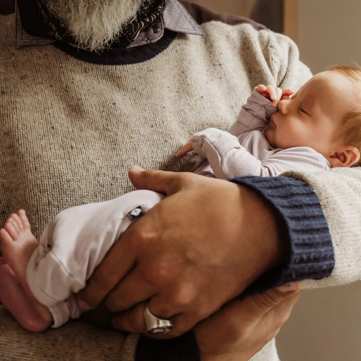 Newborn in portland photographed sleeping in grandfathers arms