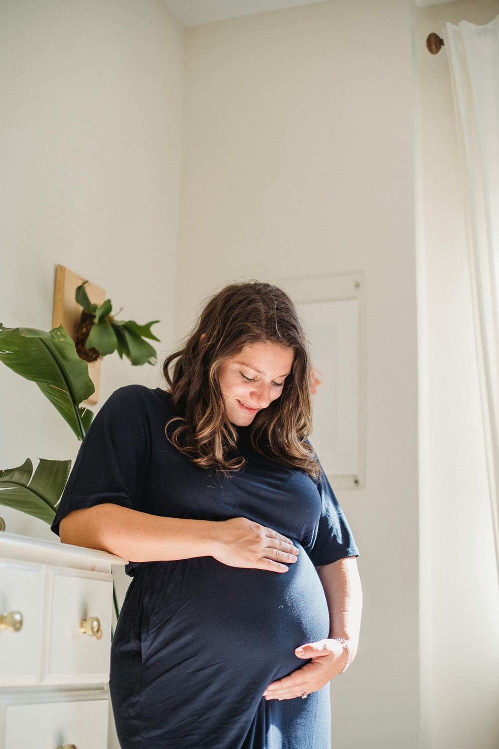 Portland mamma smiles at bump in nursery