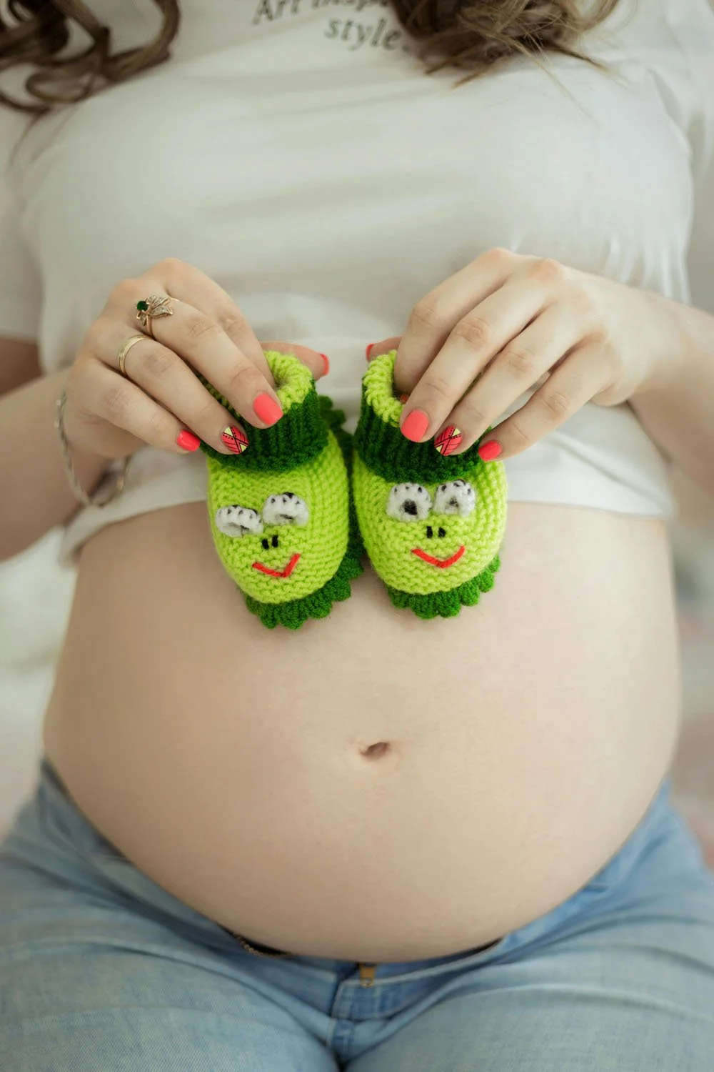 Maternity shoot using booties as a cute prop
