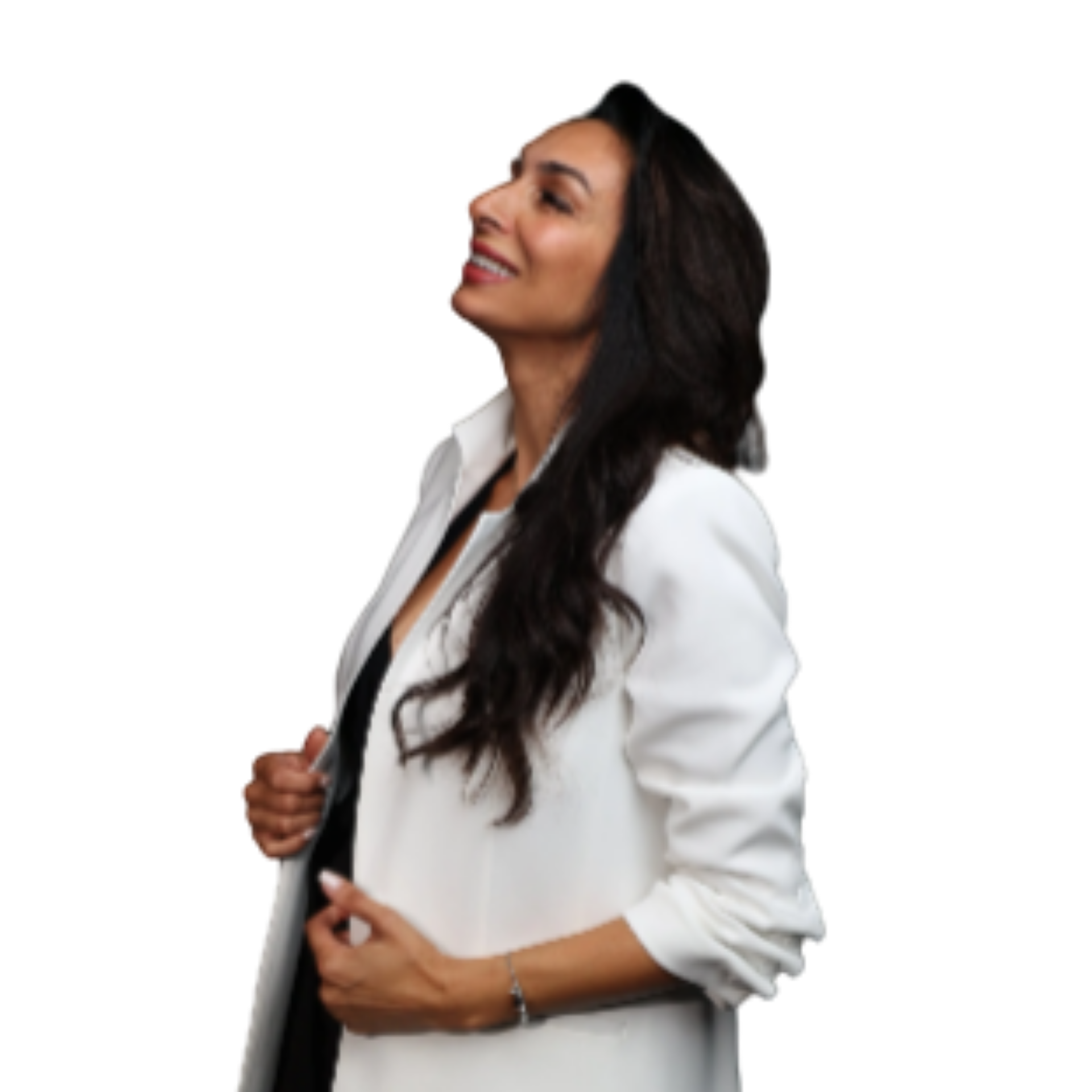 Woman with long dark hair wearing a white blazer, smiling confidently, posing with her head slightly tilted to the side.