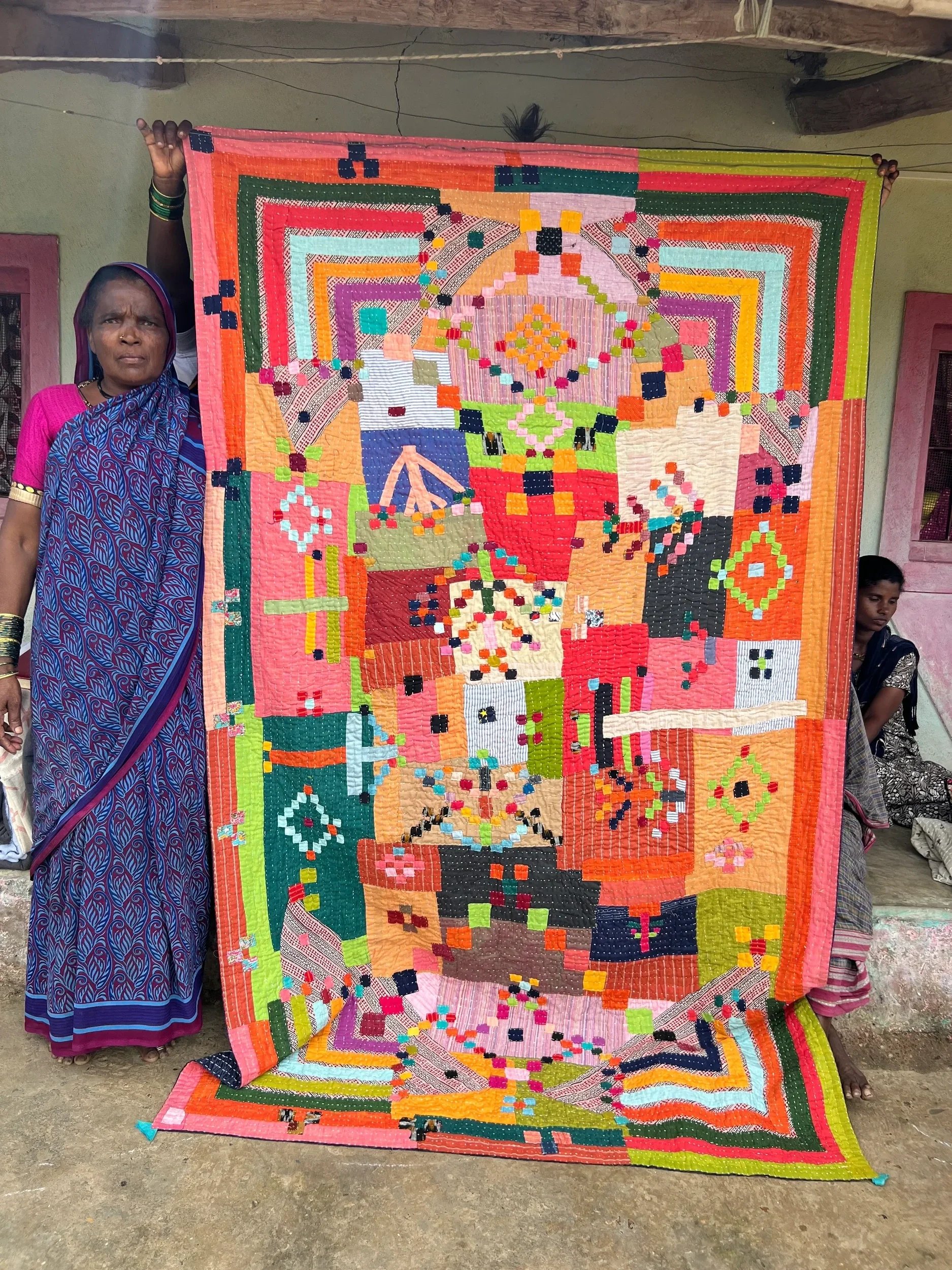 Siddi-Woman-Quilter-Holding-Up-A-Kavand-2.jpg.webp