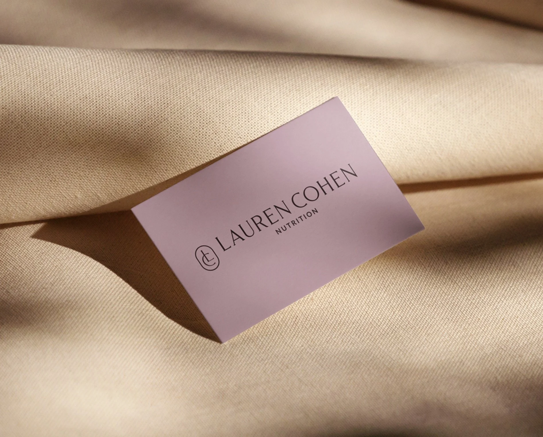 Close-up of Lauren Cohen Nutrition branding materials showcasing the refined logo and elevated color palette.