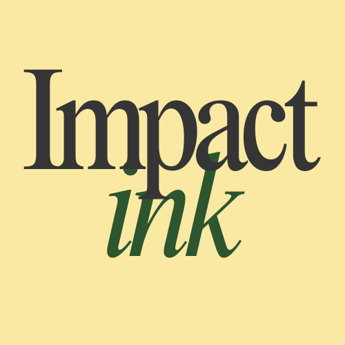 Two women sitting and conversing in front of a backdrop with repeating 'BL' text, one woman wearing a white sweater and glasses, the other in traditional Indian attire, smiling at each other.