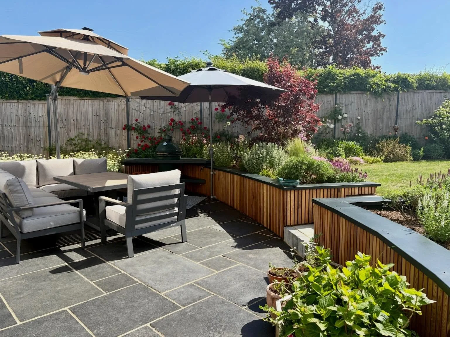 Updating just one or two existing features can really make a difference to the look and feel of a garden.  Replacing the failing sleeper retaining wall has made a significant difference to this patio area.  The new block work wall has been clad with 