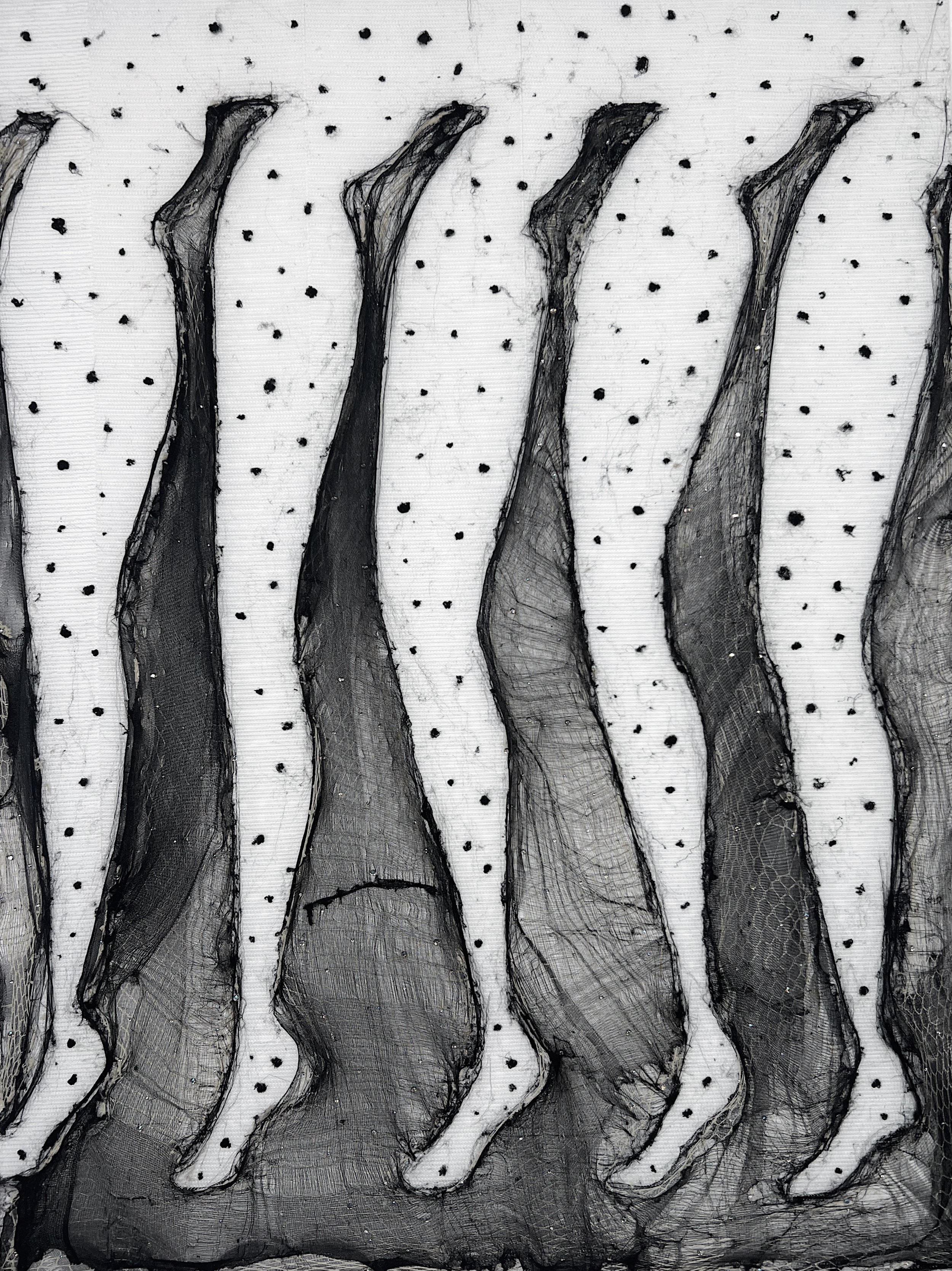 Black and white abstract art featuring elongated, irregular shapes with textured patterns, set against a dotted background.